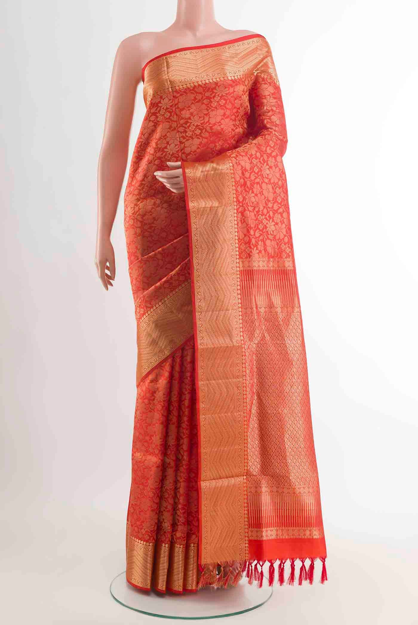 Orange Soft Silk Saree with Zari Brocade on the body and Zari Border displayed on a mannequin