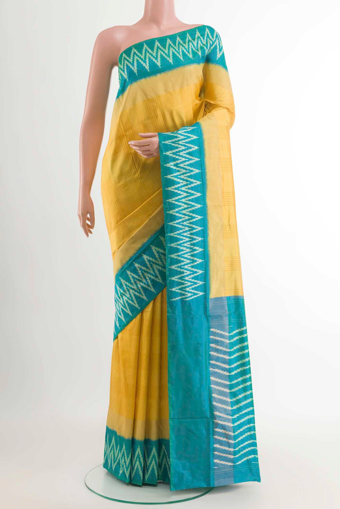 Yellow Pochampally Silk Saree with Pure Ikat on the body and Ikat Border displayed on a mannequin