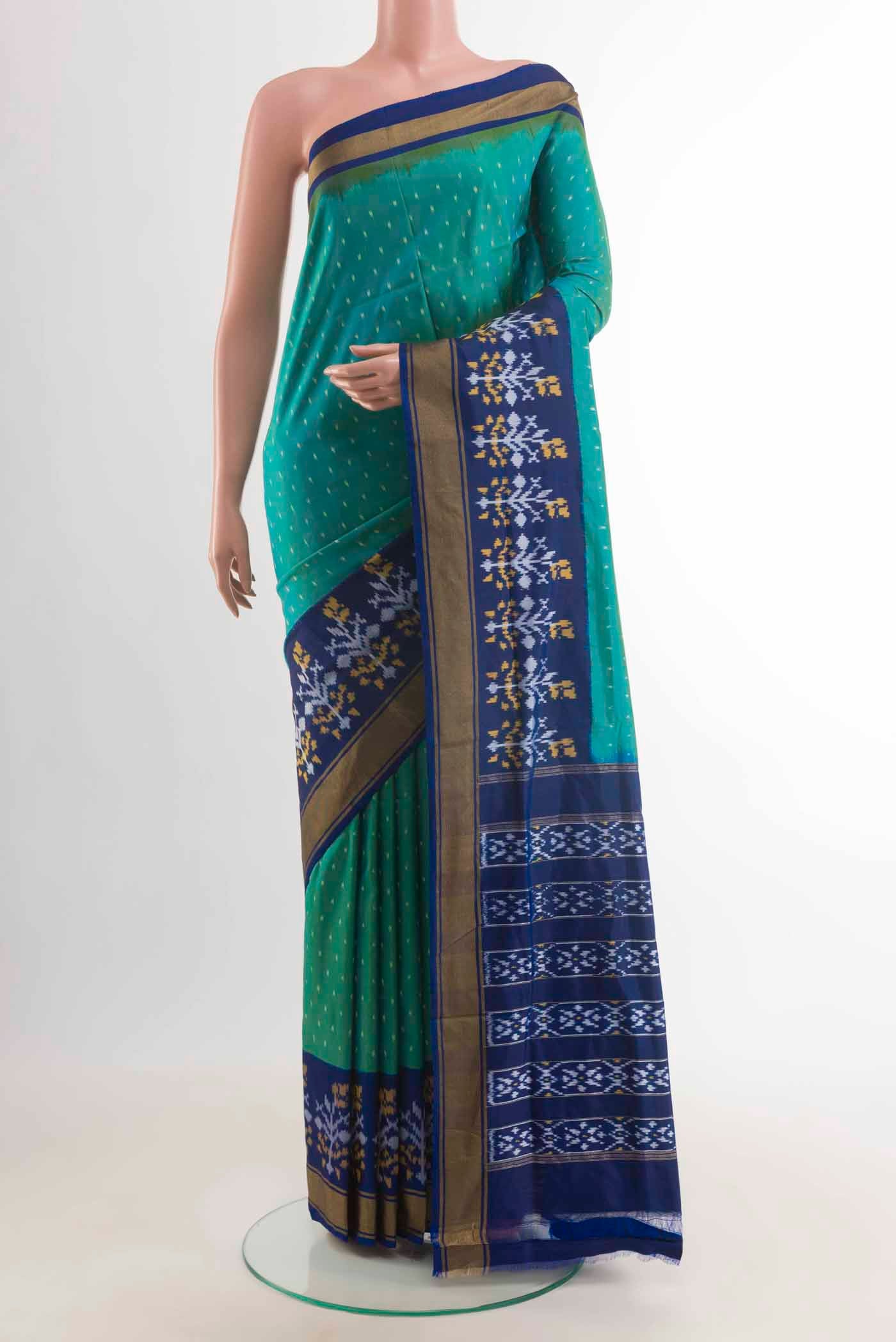 Sea Green Pochampally Silk Saree with Ikat design on the body and Zari Border displayed on a mannequin