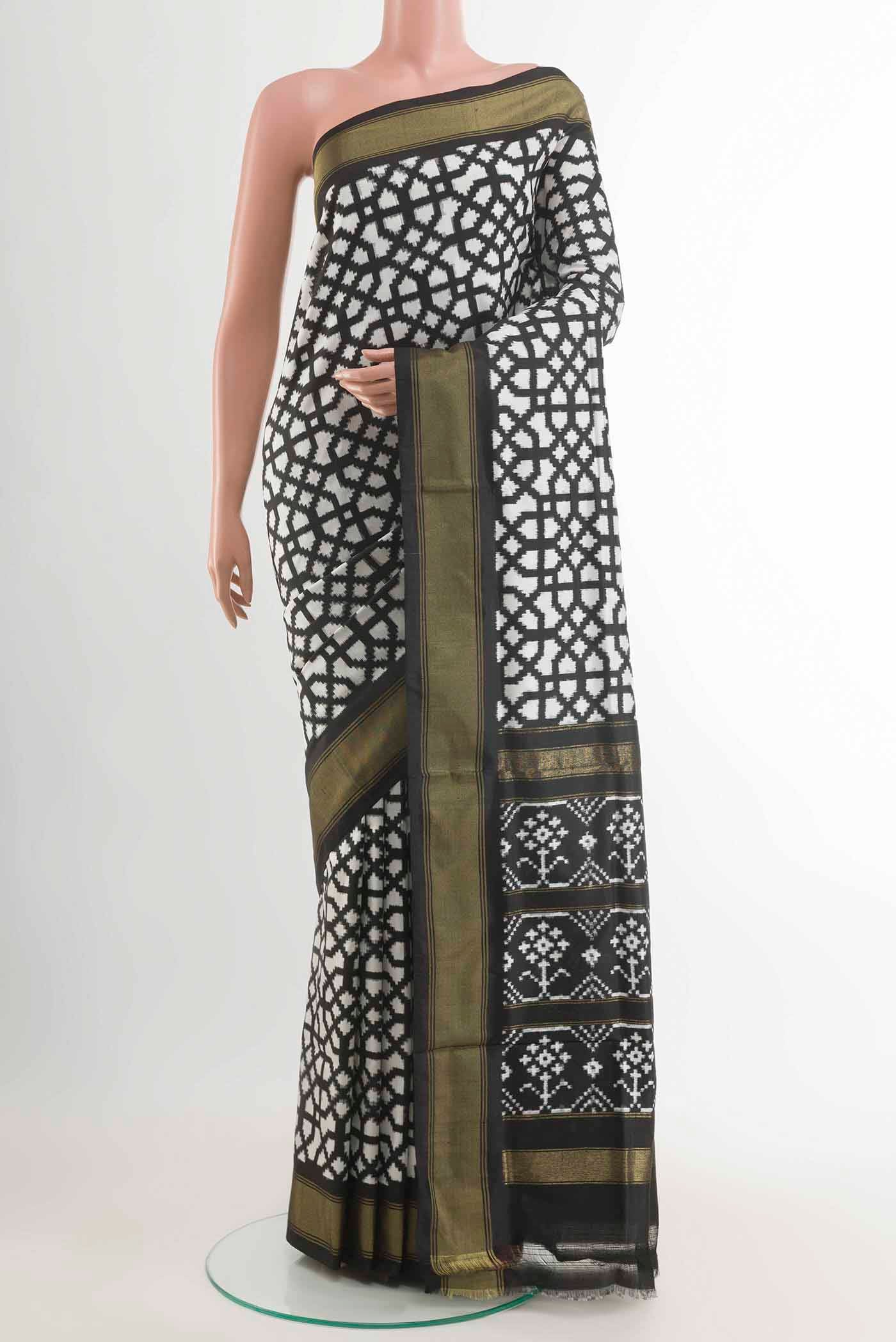 Off White Pochampally Silk Saree with Pure Ikat on the body and Zari Border displayed on a mannequin