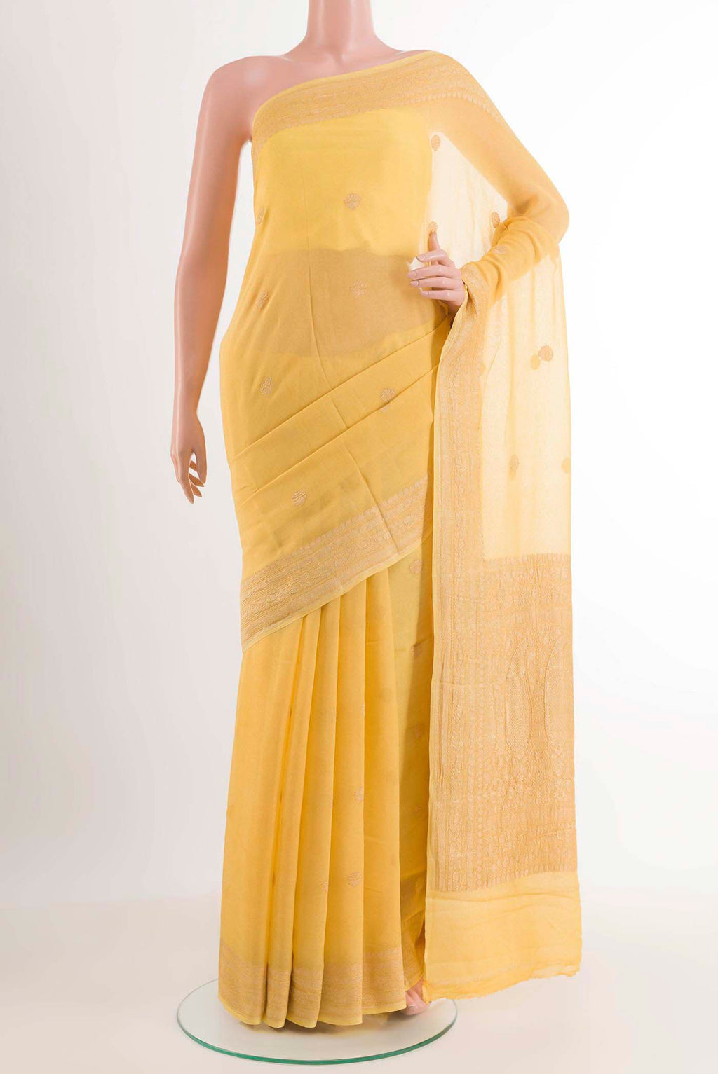 Yellow Mysore Chiffon Saree with Zari Butta on the body and Zari Border displayed on a mannequin