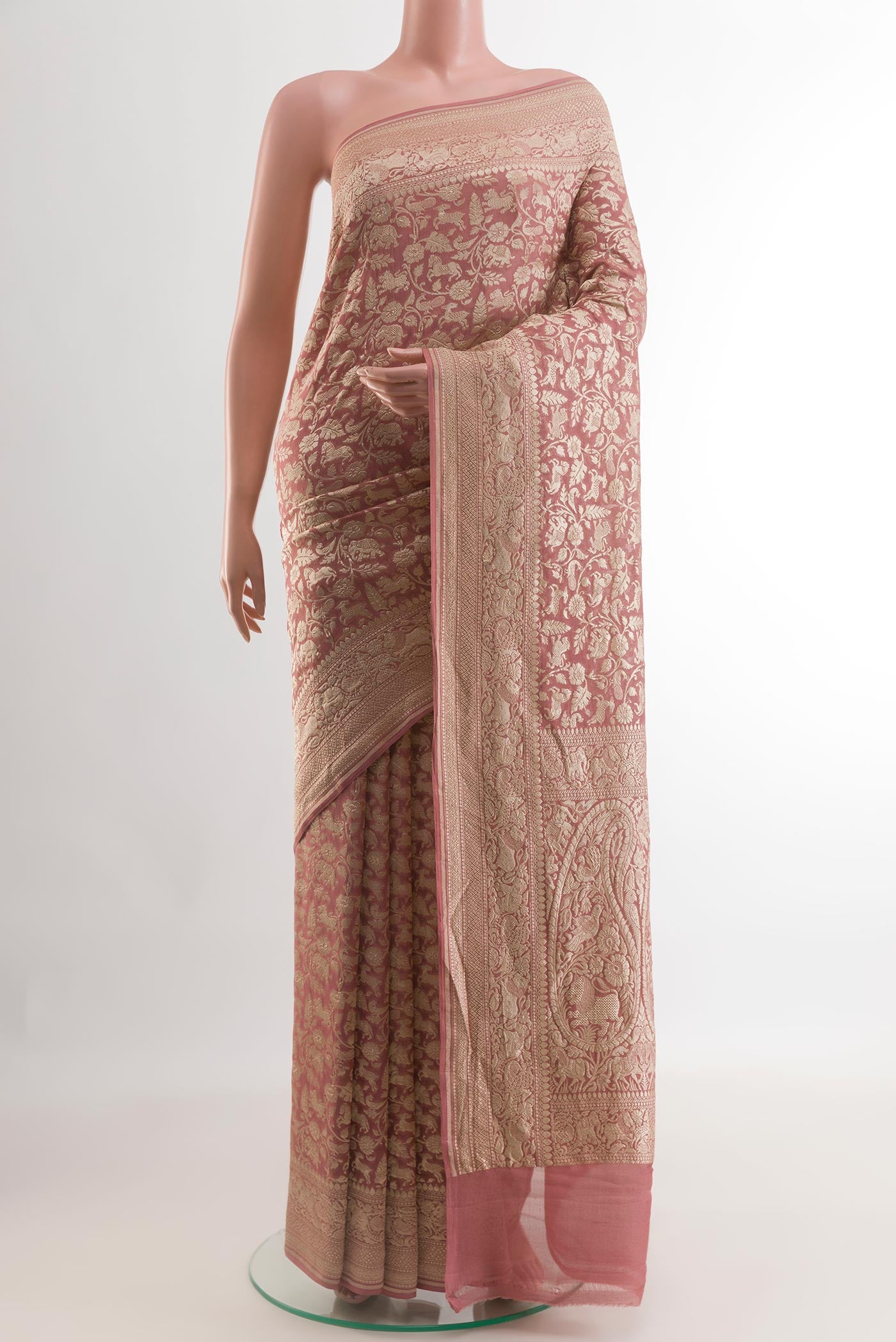Rose Gold Banarasi Georgette Saree with Zari Brocade on the body and Zari Border.  displayed on a mannequin