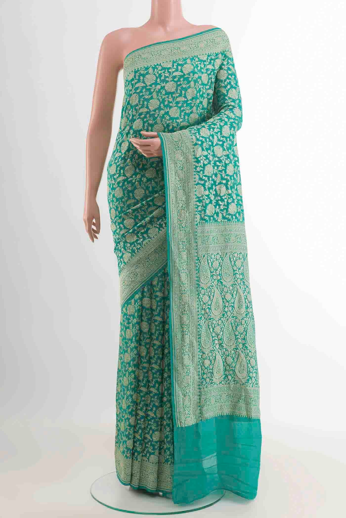 Turquoise Banarasi Georgette Saree with Zari Brocade on the body and Zari Border displayed on a mannequin