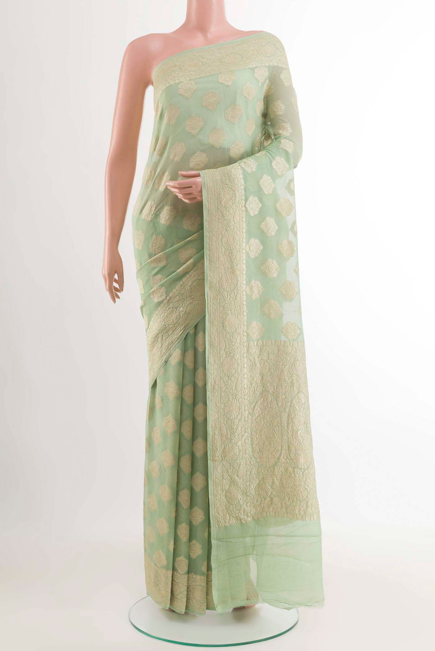 Sage Green Banarasi Georgette Saree with Zari Butta on the body and Zari Border displayed on a mannequin