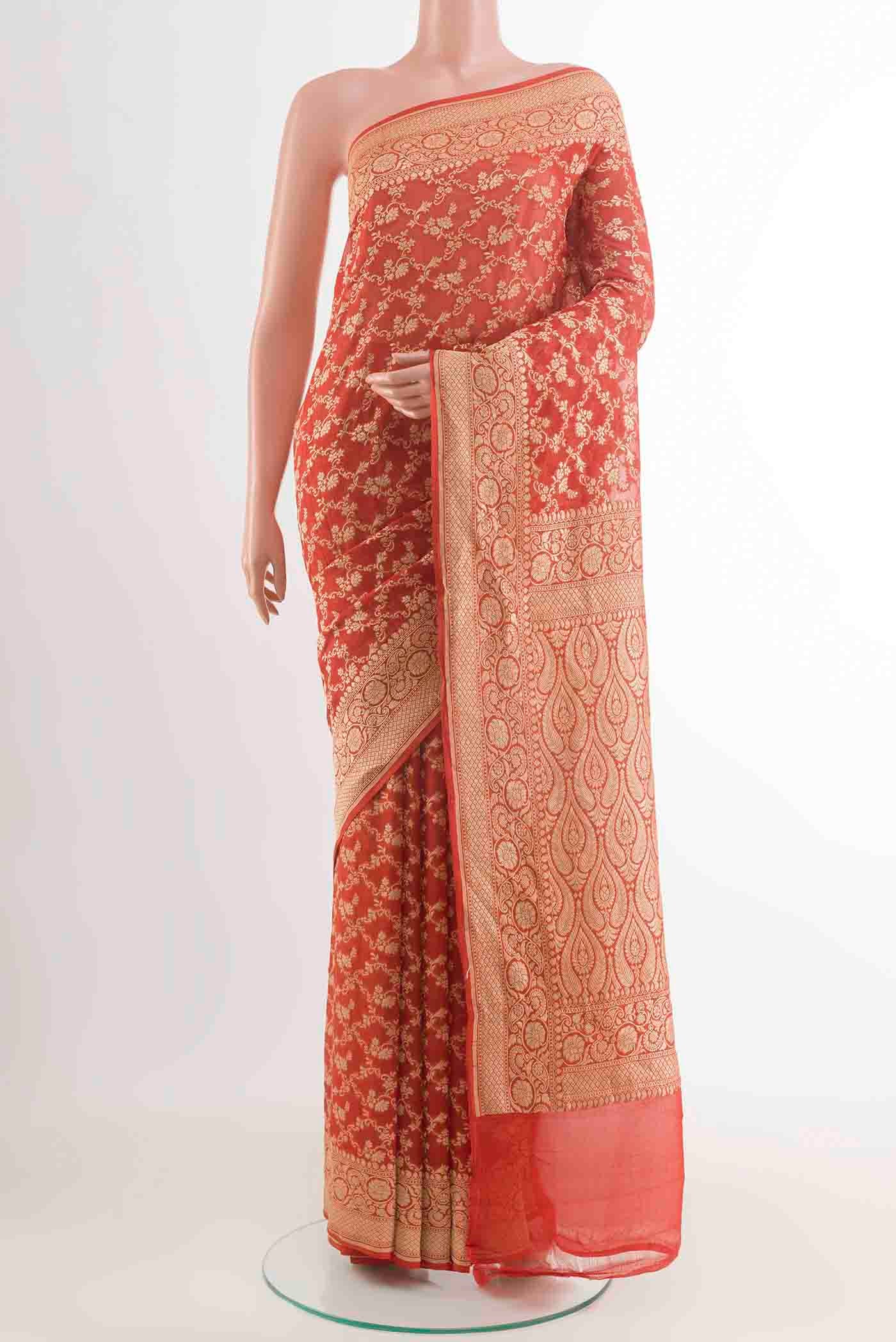 Orange Banarasi Georgette Saree with Zari Brocade on the body and Zari Border displayed on a mannequin