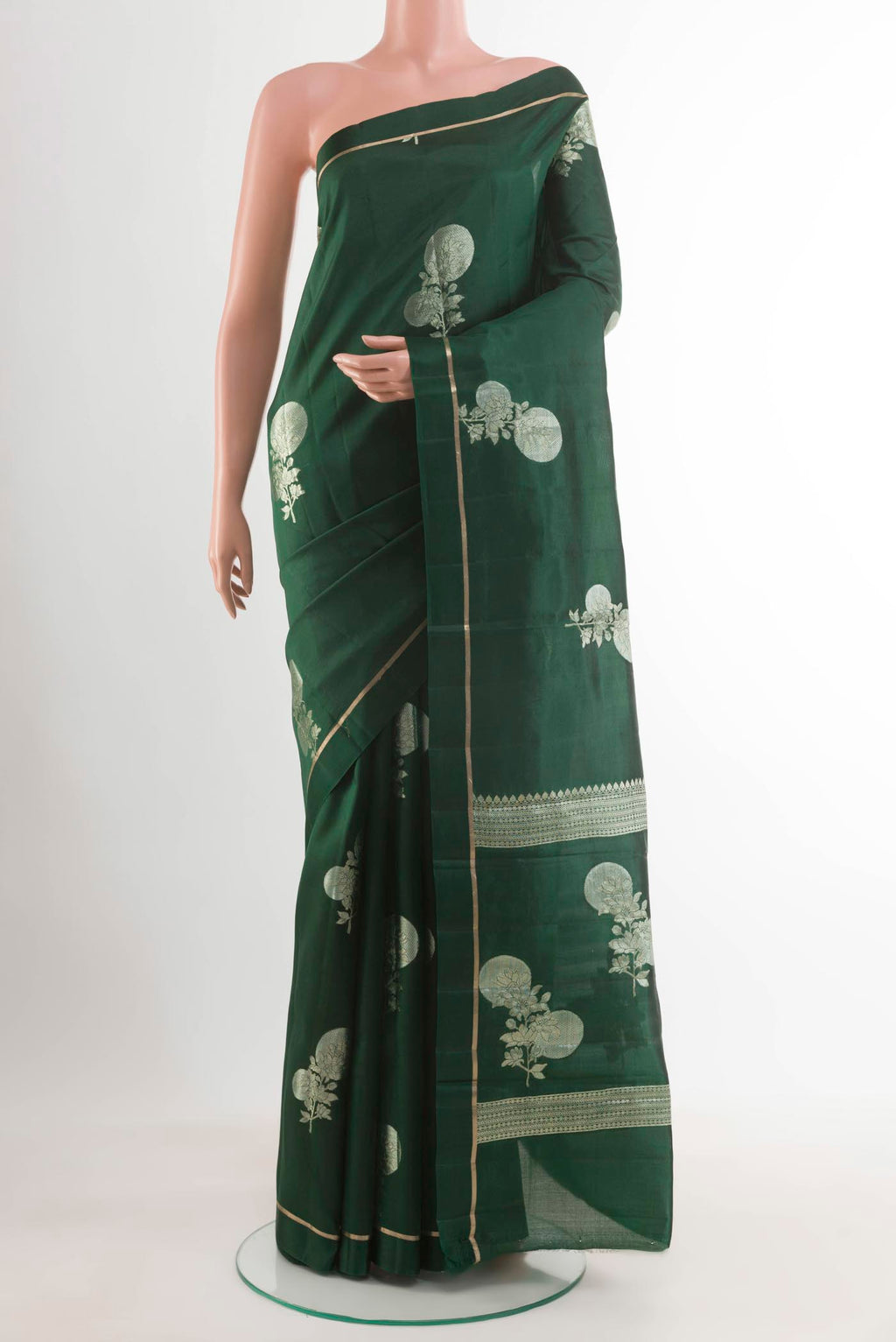 Bottle Green Banarasi Raw Silk Saree with Zari Butta on the body and Thin Zari Line displayed on a mannequin