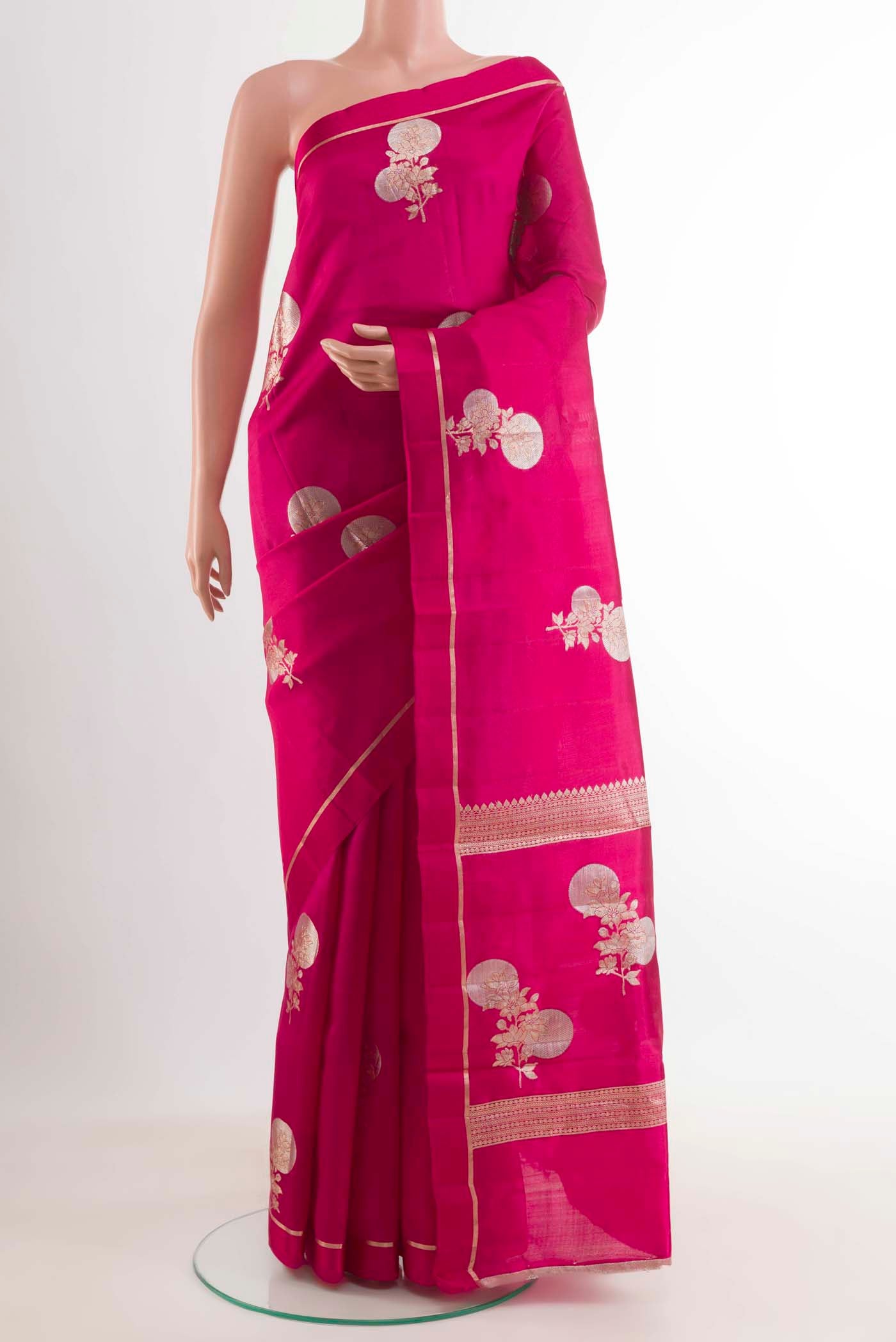 Rani Pink Banarasi Raw Silk Saree with Zari Butta on the body and Thin Zari Line displayed on a mannequin