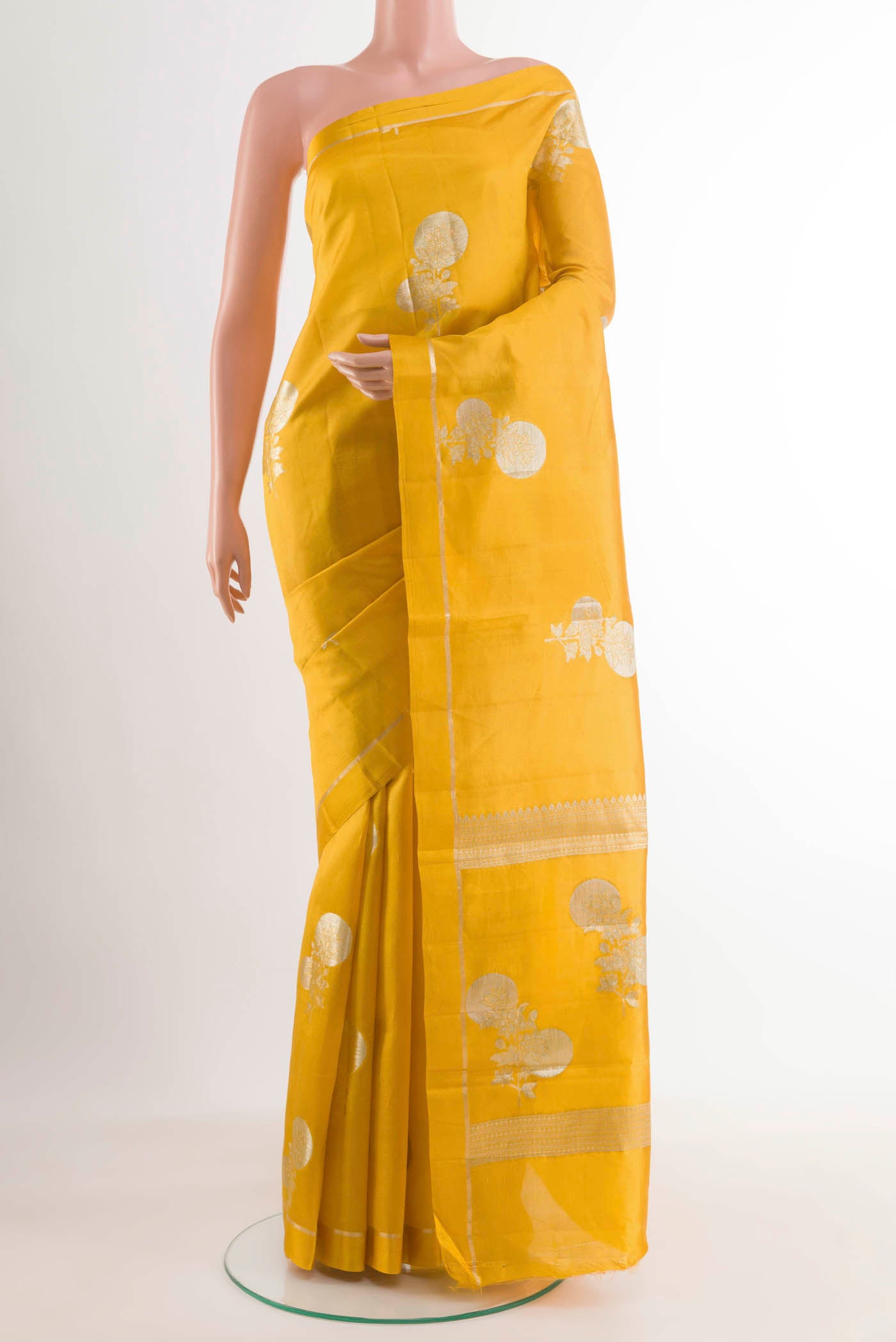 Yellow Banarasi Raw Silk Saree with Zari Butta on the body and Zari Border displayed on a mannequin