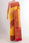 Yellow Rajkot Patola Silk Saree with Ikat design on the body and Zari Border displayed on a mannequin