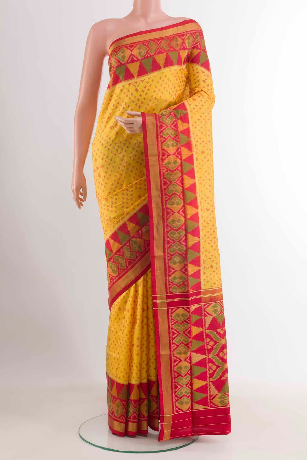 Yellow Rajkot Patola Silk Saree with Ikat design on the body and Zari Border displayed on a mannequin