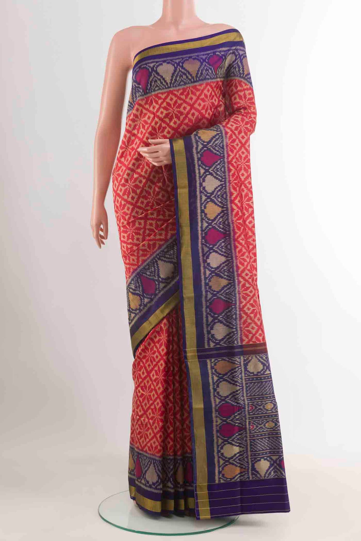 Red Rajkot Patola Silk Saree with Ikat design on the body and Zari Border displayed on a mannequin