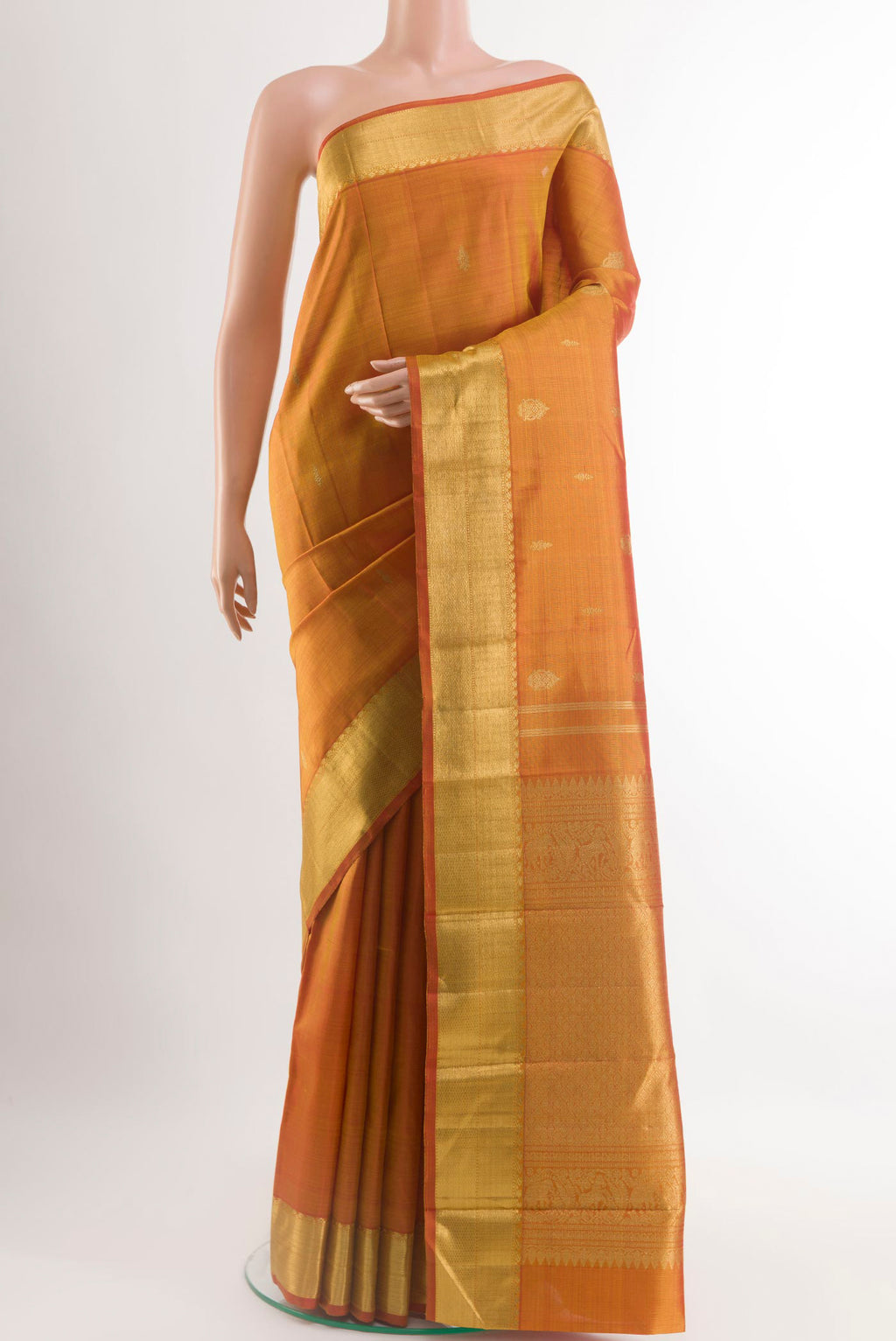 Peach Kanjivaram Silk Saree with Zari Brocade on the body and Zari Border.  displayed on a mannequin
