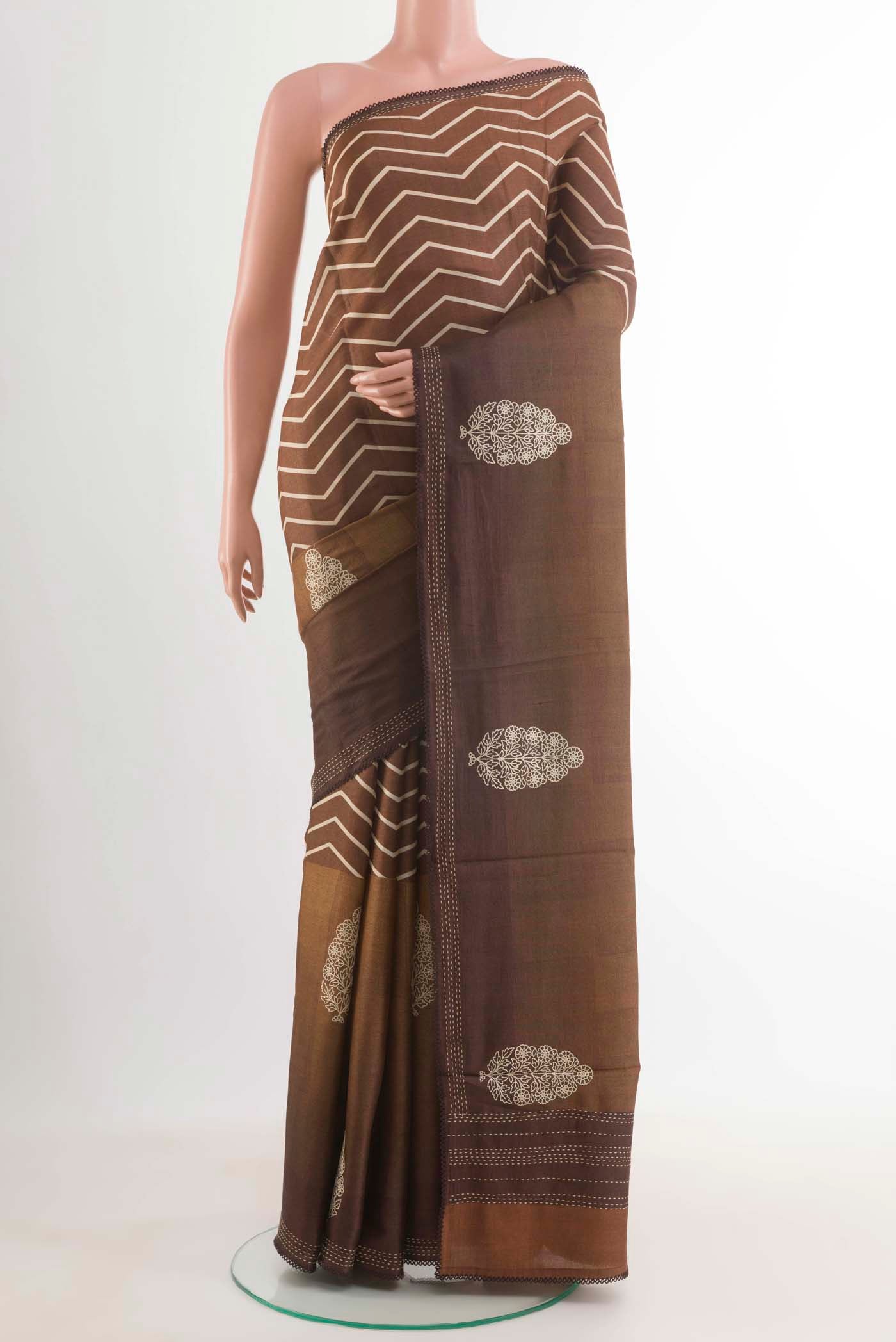 Brown Tussar Silk Saree with Zig Zag design on the body and Embroidery Border displayed on a mannequin