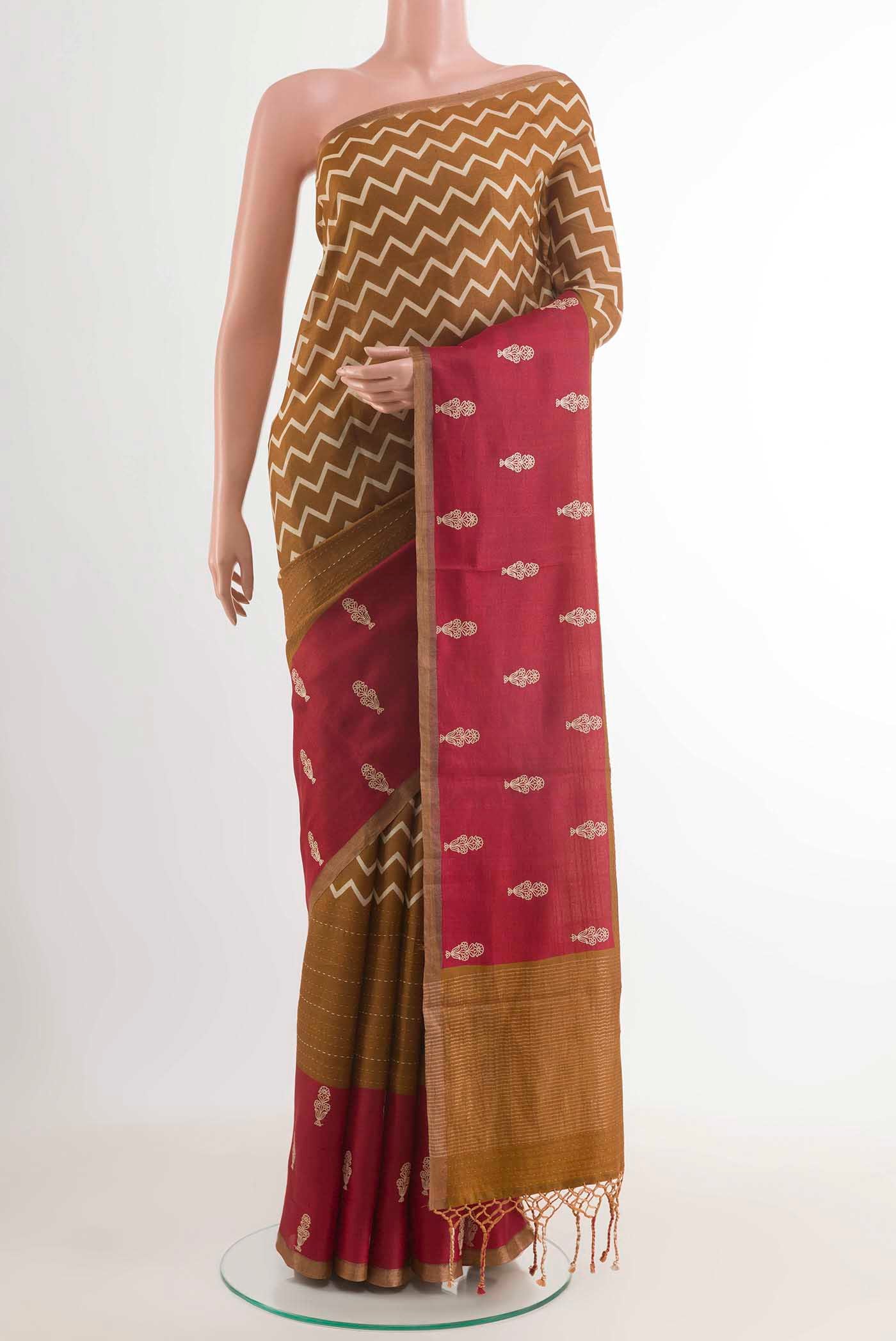 Mustard Tussar Saree with Printed design on the body and Plain Border displayed on a mannequin