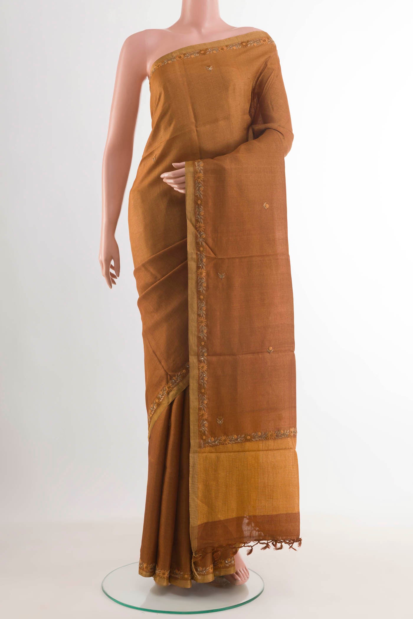 Brown Tussar Silk Saree with Embroidery on the body and Embroidery Border displayed on a mannequin