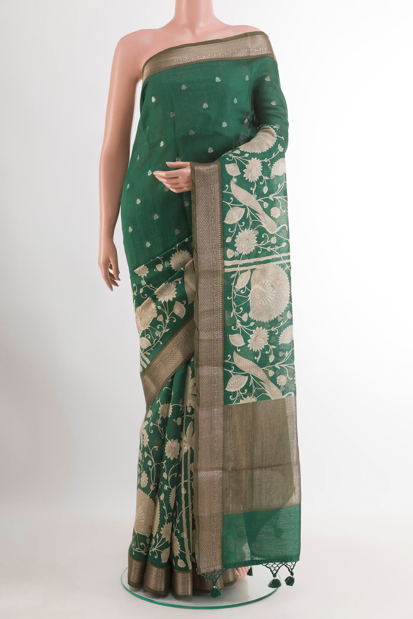 Green Tussar Saree with Printed design on the body and Zari Border.  displayed on a mannequin