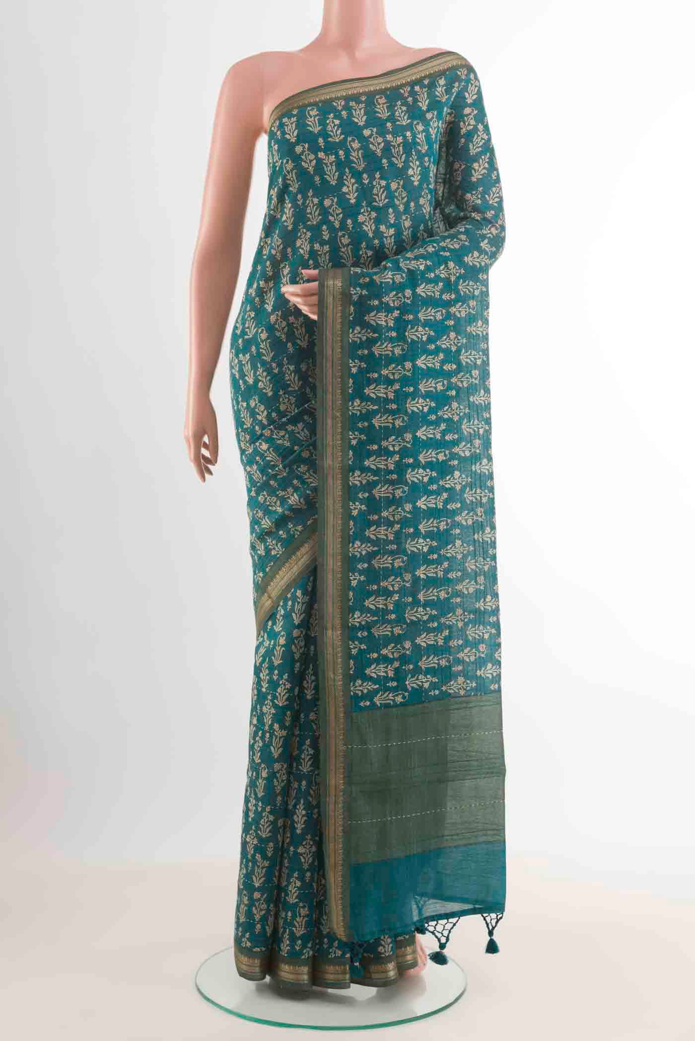 Blue Tussar Silk Saree with Floral Print on the body and Zari Border displayed on a mannequin