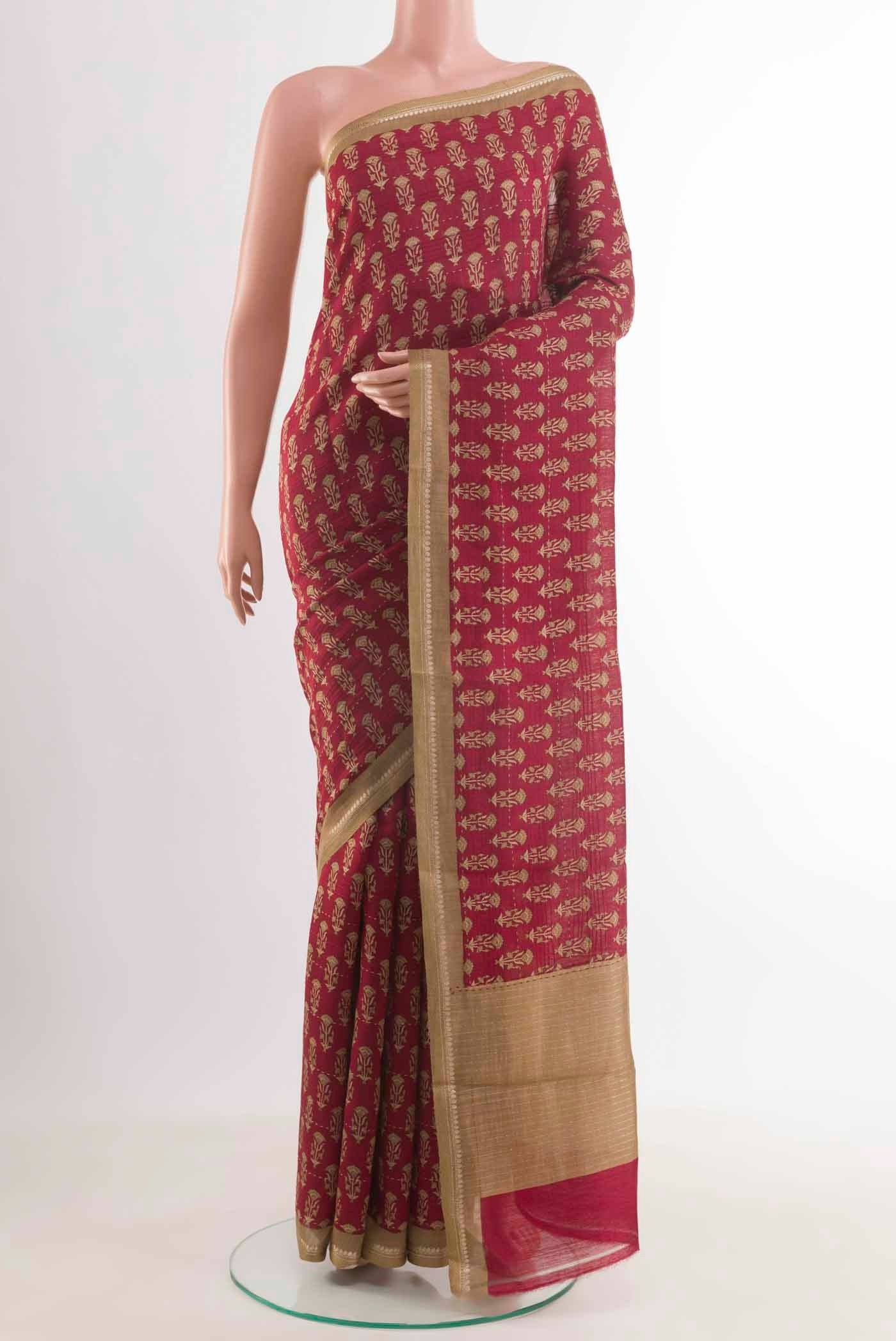 Maroon Tussar Silk Saree with Printed design on the body and Zari Border displayed on a mannequin