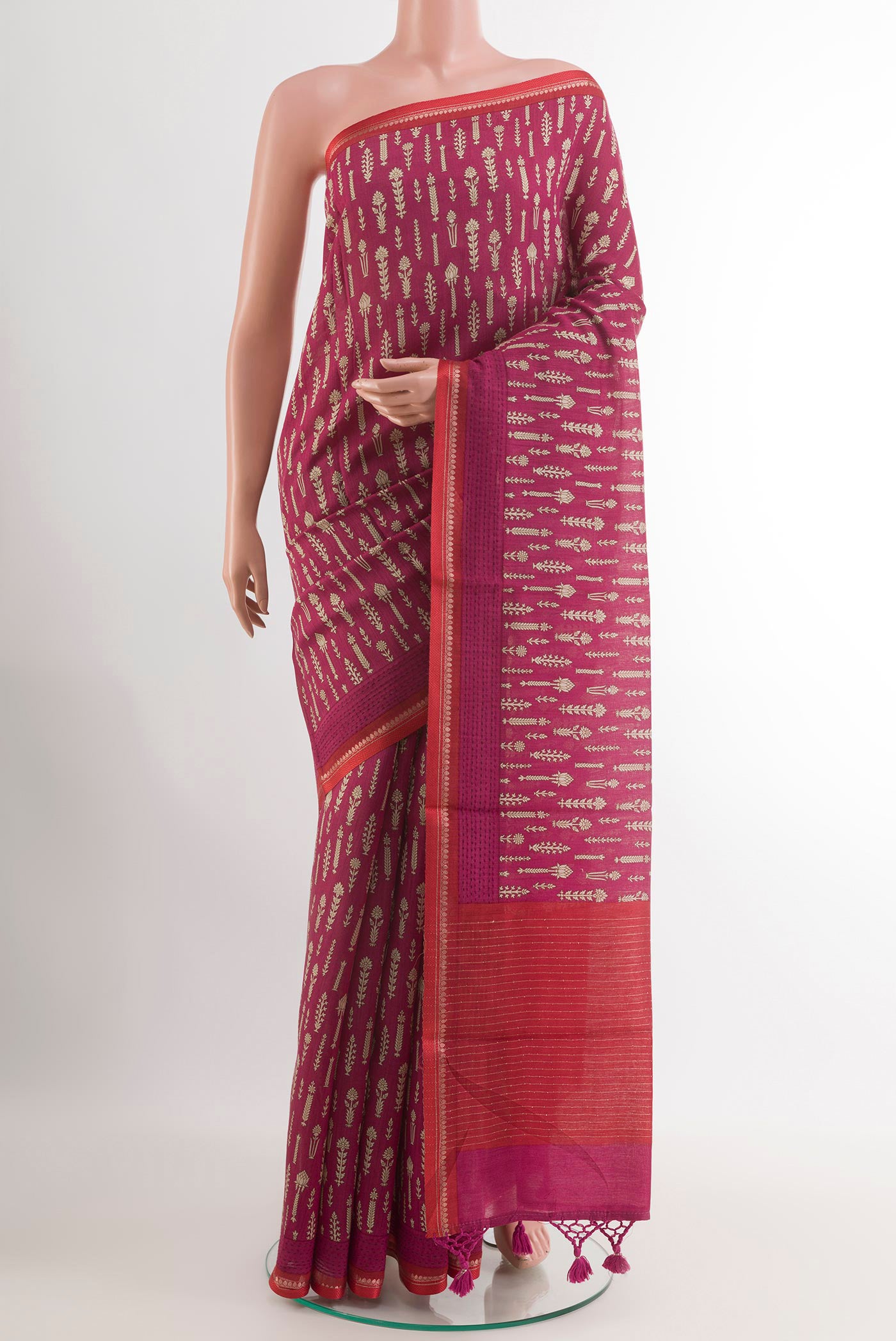 Magenta Tussar Saree with Printed design on the body and Zari Border.  displayed on a mannequin