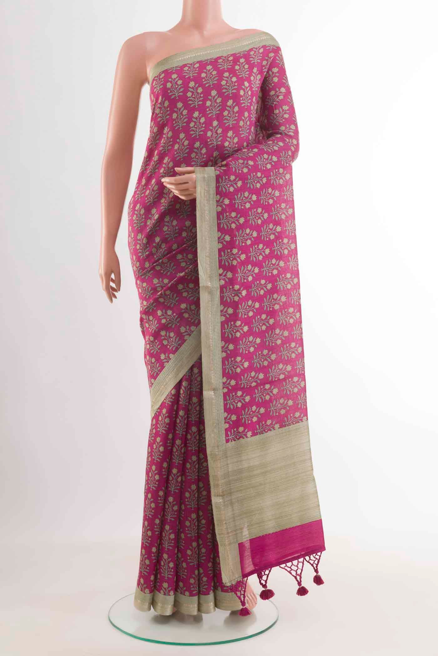 Magenta Tussar Silk Saree with Printed design on the body and Zari Border displayed on a mannequin