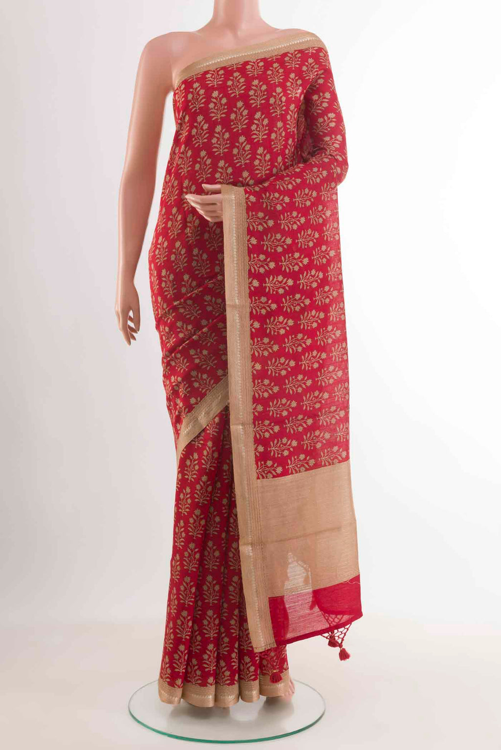 Red Tussar Silk Saree with Printed design on the body and Zari Border displayed on a mannequin