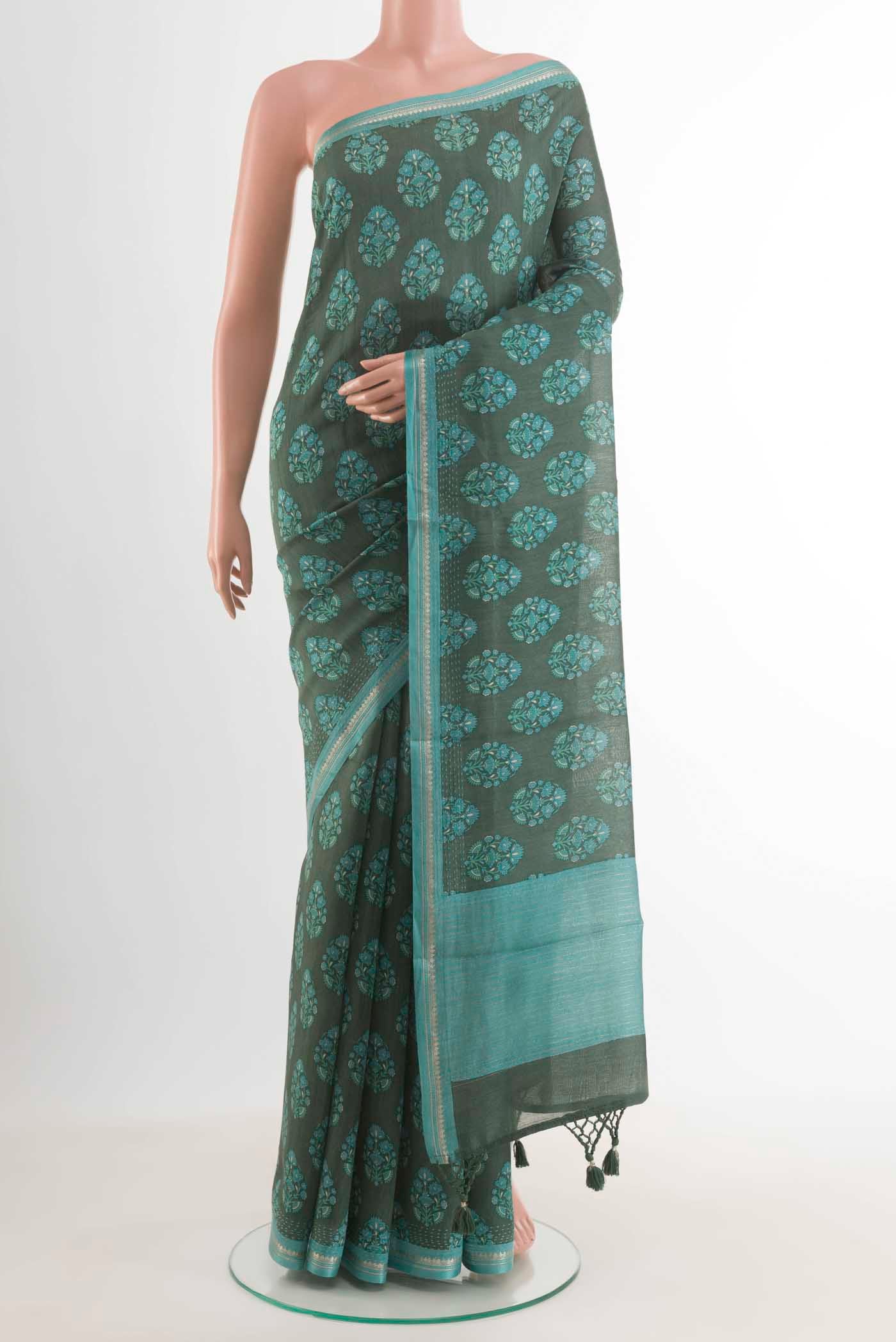 Green Tussar Silk Saree with Floral Print on the body and Zari Border displayed on a mannequin