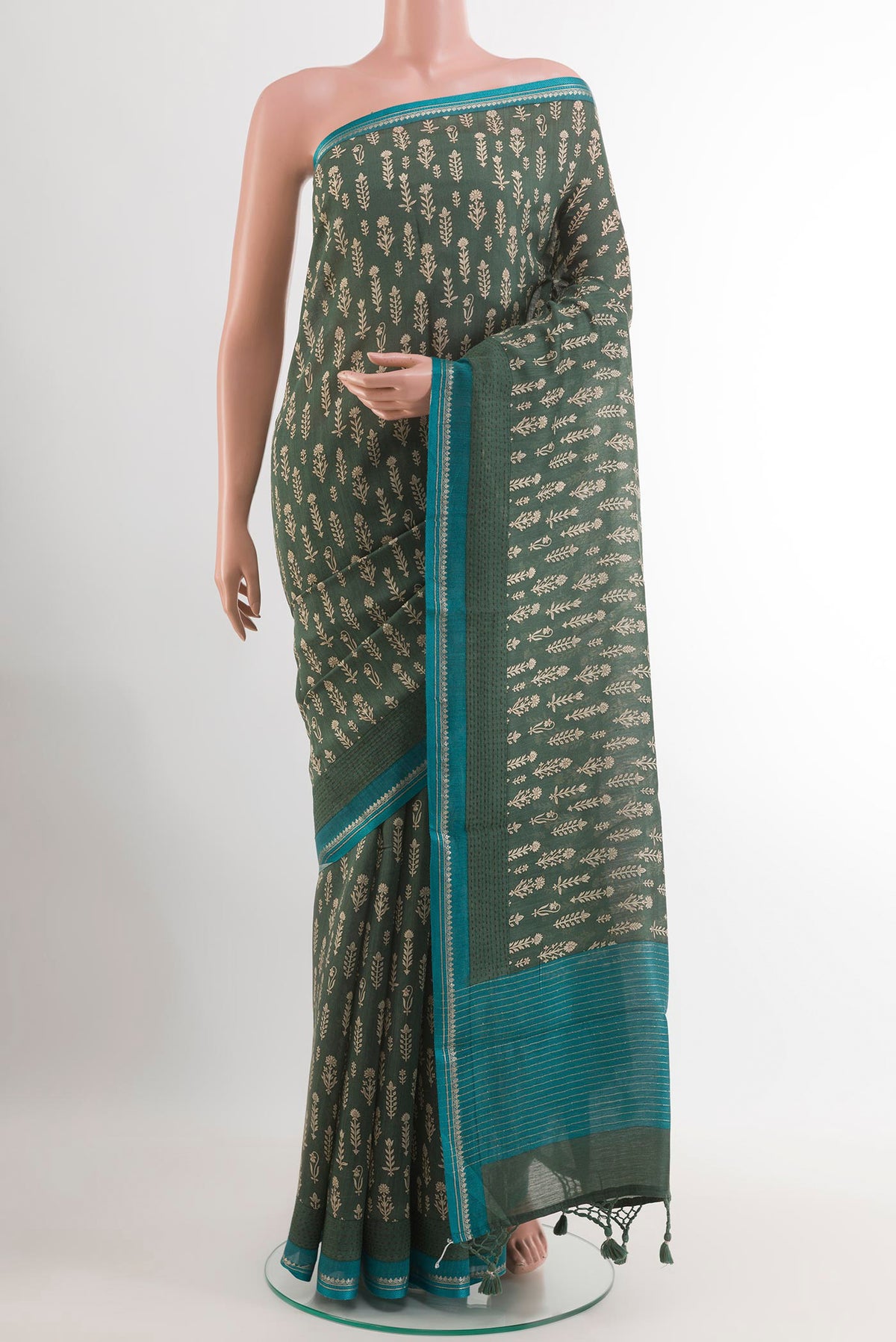 Green Tussar Saree with Printed design on the body and Thread Embroidery Border.  displayed on a mannequin