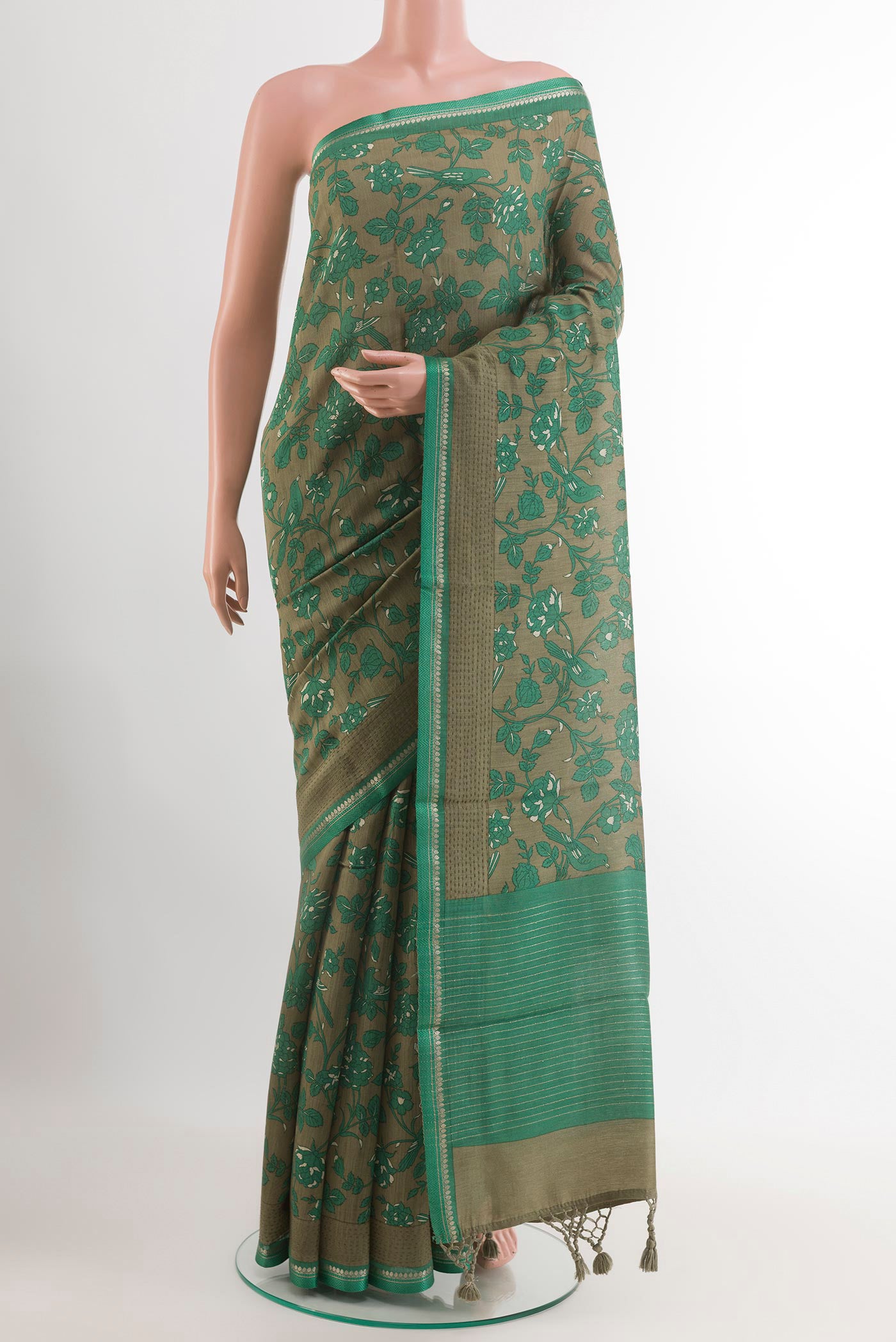 Mehandi Green Tussar Saree with Printed design on the body and Thread Embroidery Border.  displayed on a mannequin