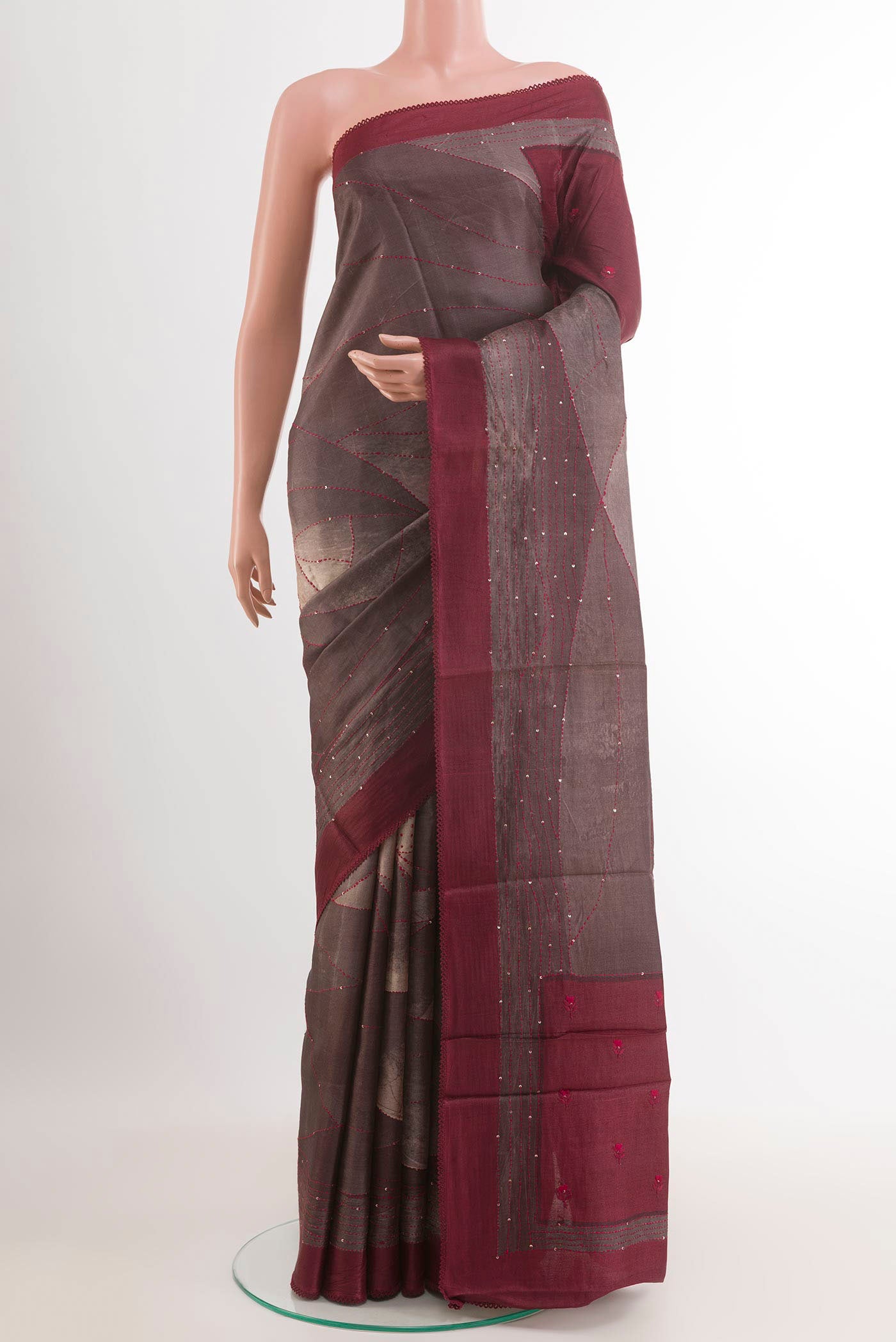 Grey Tussar Saree with Printed design on the body and Zari Border.  displayed on a mannequin