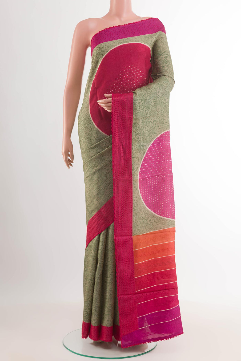 Green Tussar Saree with Printed design on the body and Embroidery Border.  displayed on a mannequin