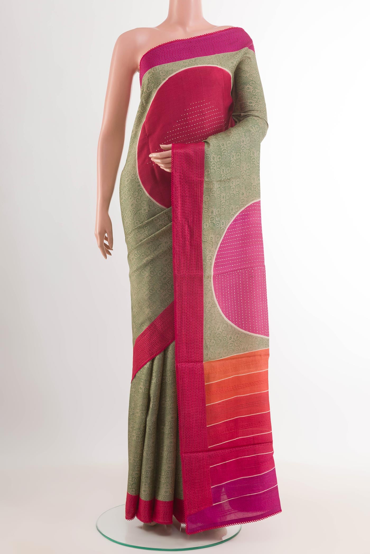 Green Tussar Saree with Printed design on the body and Embroidery Border.  displayed on a mannequin