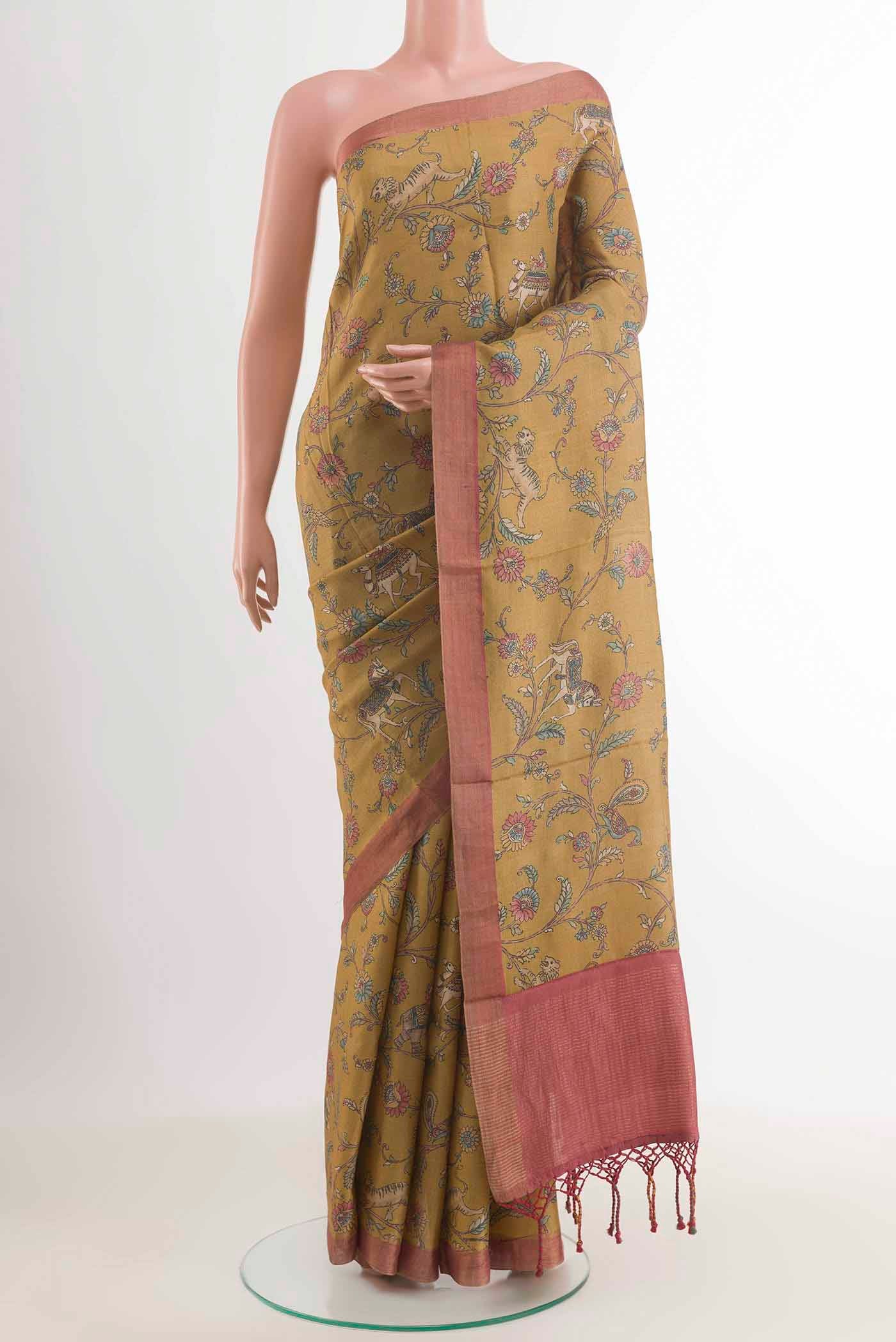 Mehandi Green Tussar Saree with Printed design on the body and Zari Border displayed on a mannequin