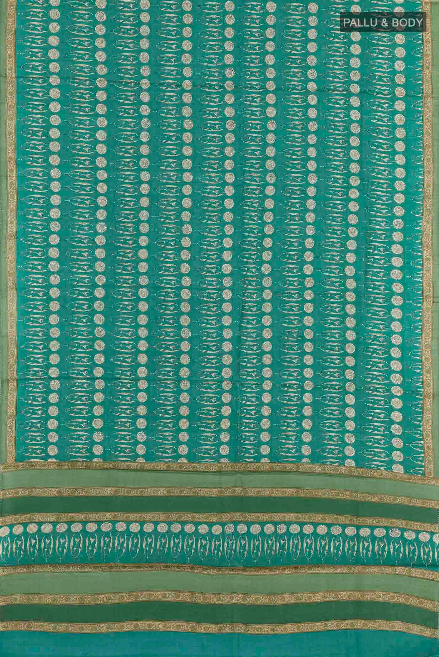 Flat view of Green Tussar Saree with Printed design on the body and Printed Border. 