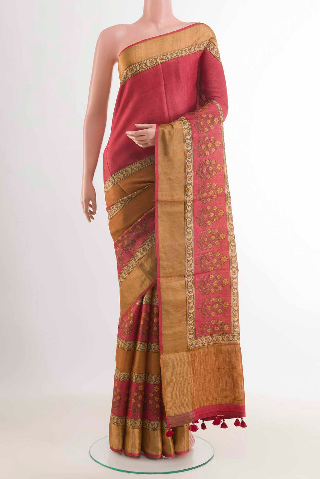 Red Tussar Saree with Printed design on the body and Zari Border displayed on a mannequin