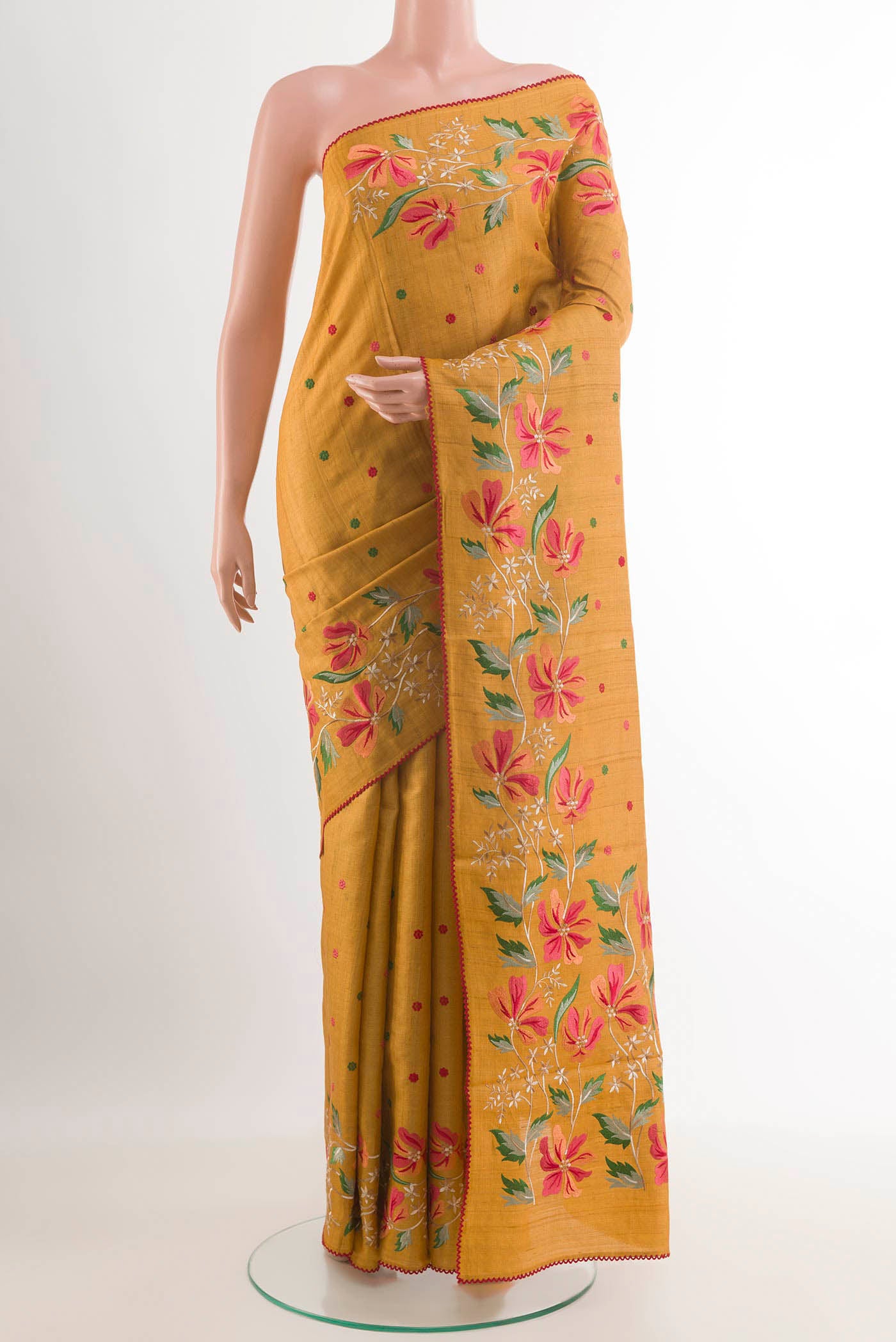 Mustard Tussar Saree with Thread Butta on the body and Embroidery Border.  displayed on a mannequin