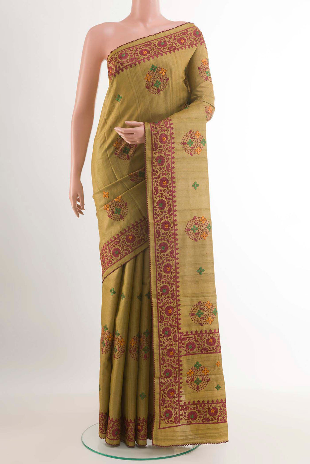 Mehandi Green Tussar Saree with Thread Butta on the body and Embroidery Border.  displayed on a mannequin