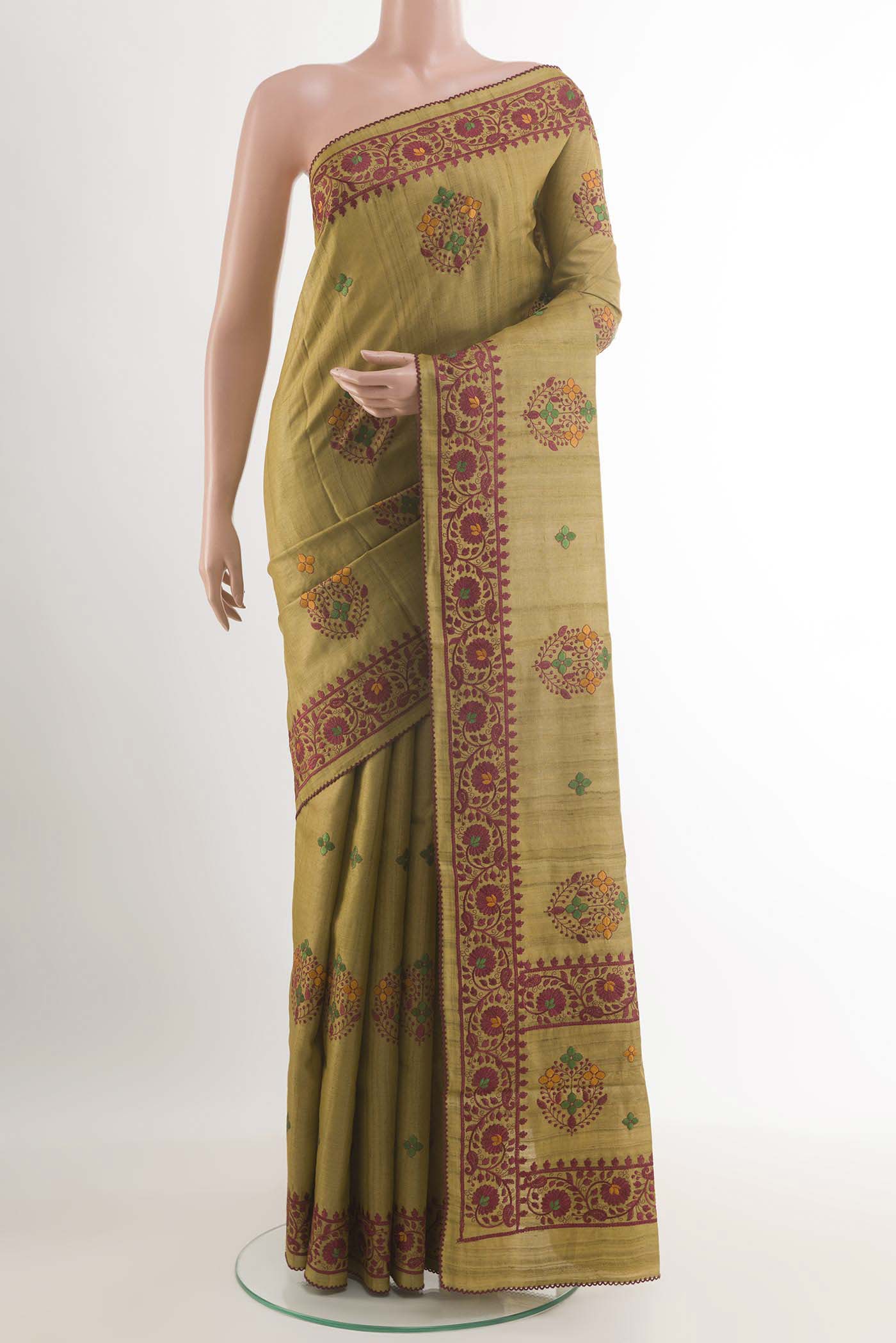 Mehandi Green Tussar Saree with Thread Butta on the body and Embroidery Border.  displayed on a mannequin