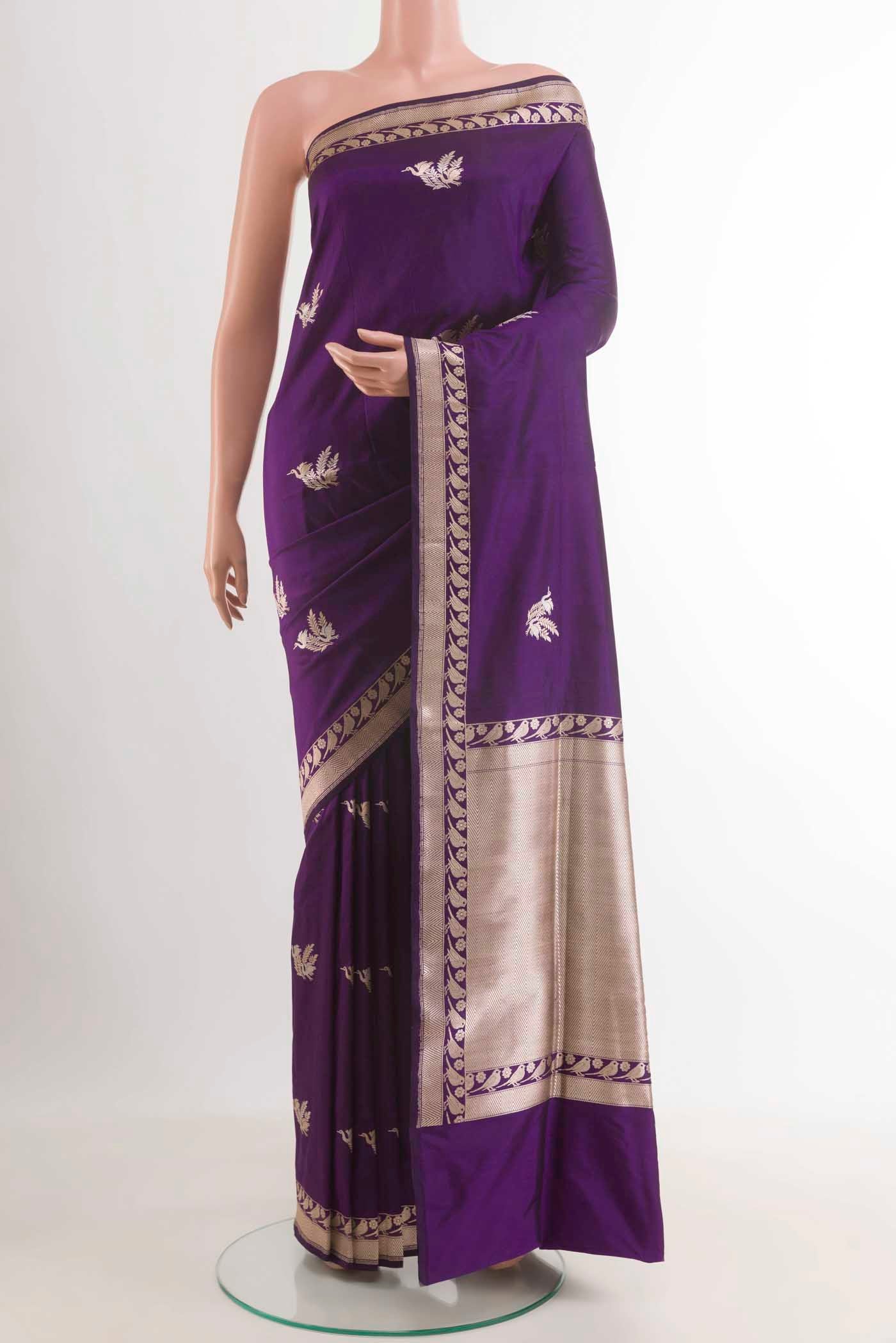 Purple Banarasi Silk Saree with Zari Butta on the body and Zari Border.  displayed on a mannequin
