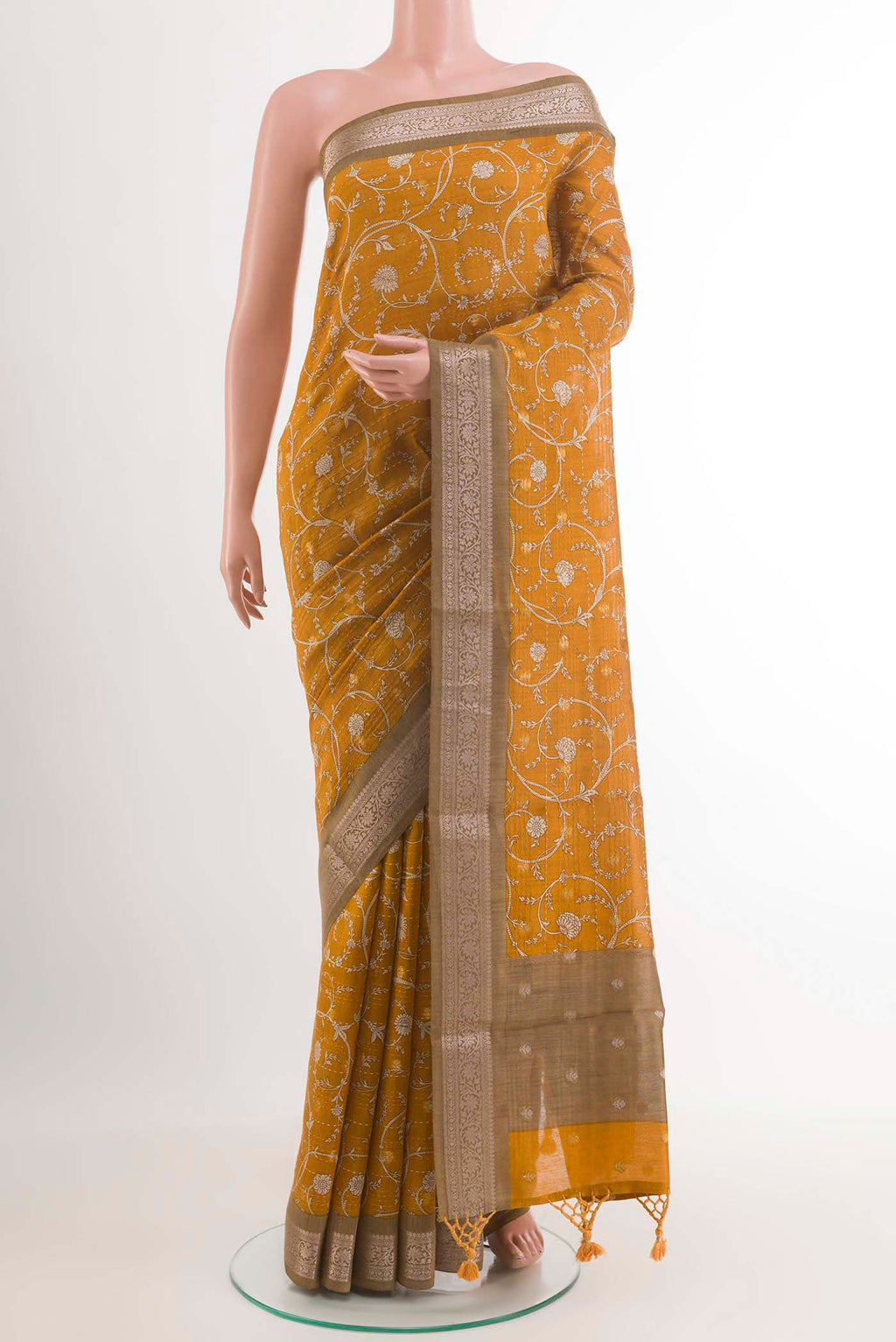 Yellow Tussar Saree with Printed design on the body and Zari Border.  displayed on a mannequin