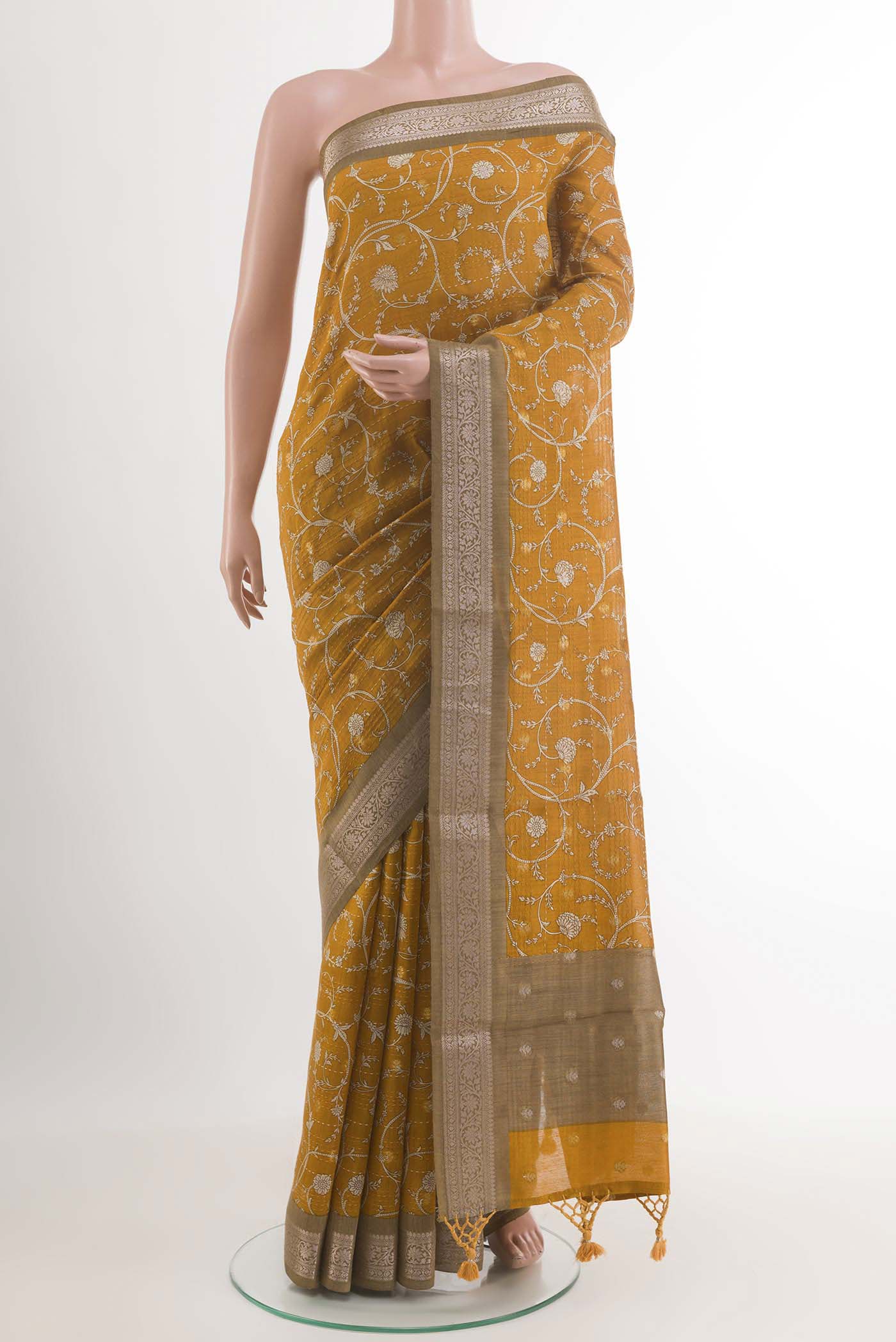 Yellow Tussar Saree with Printed design on the body and Zari Border.  displayed on a mannequin