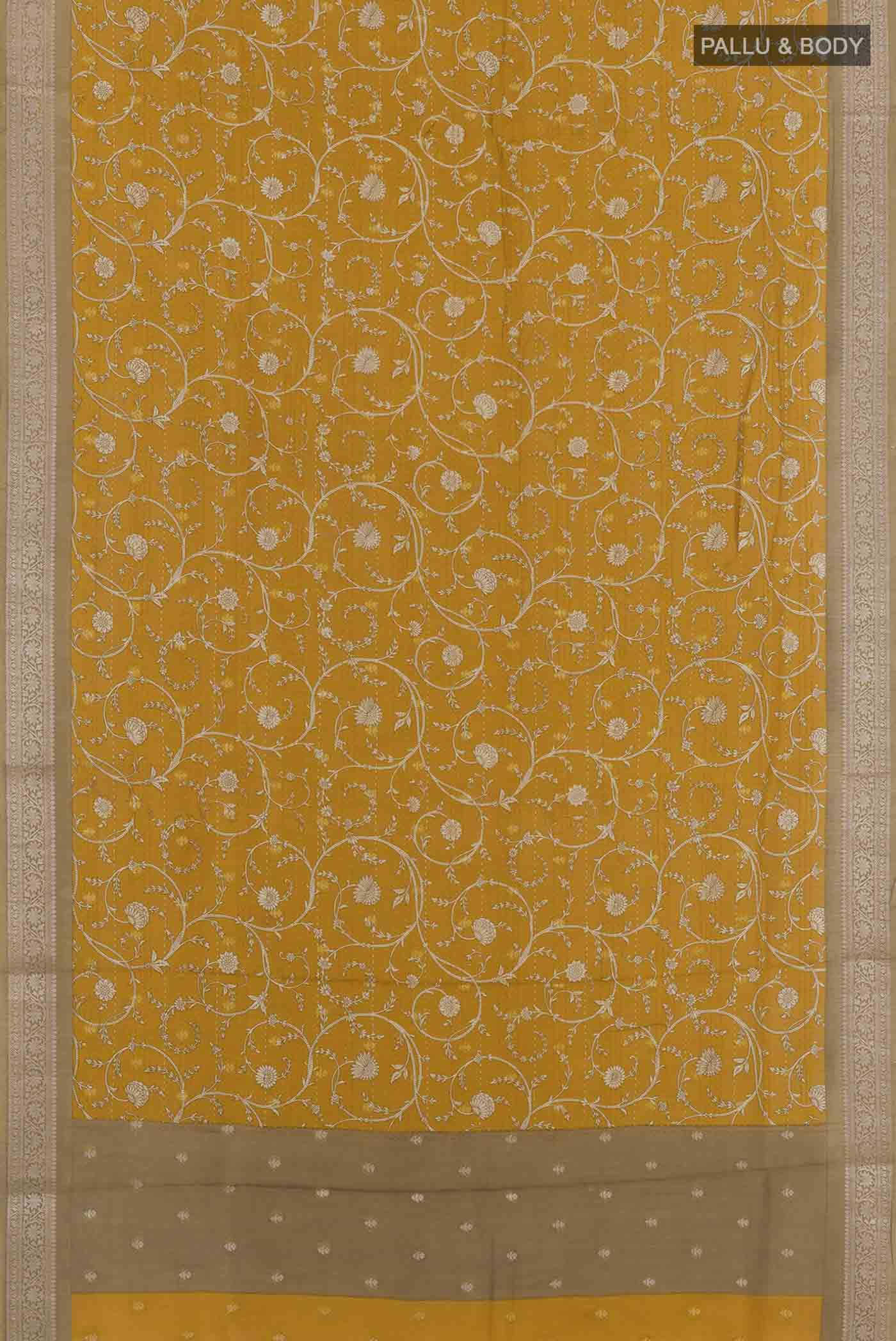 Flat view of Yellow Tussar Saree with Printed design on the body and Zari Border. 