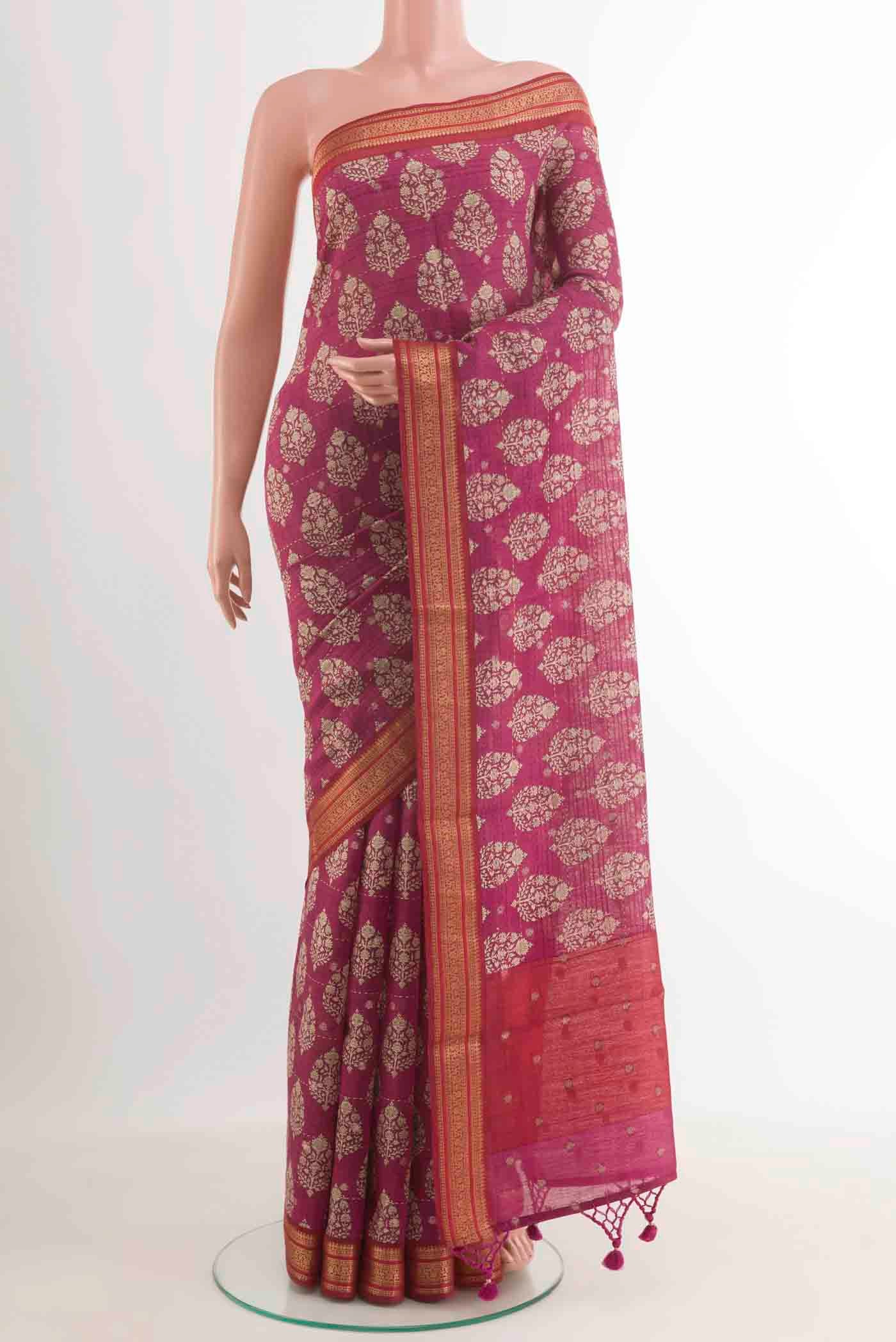 Pink Tussar Saree with Printed design on the body and Zari Border.  displayed on a mannequin