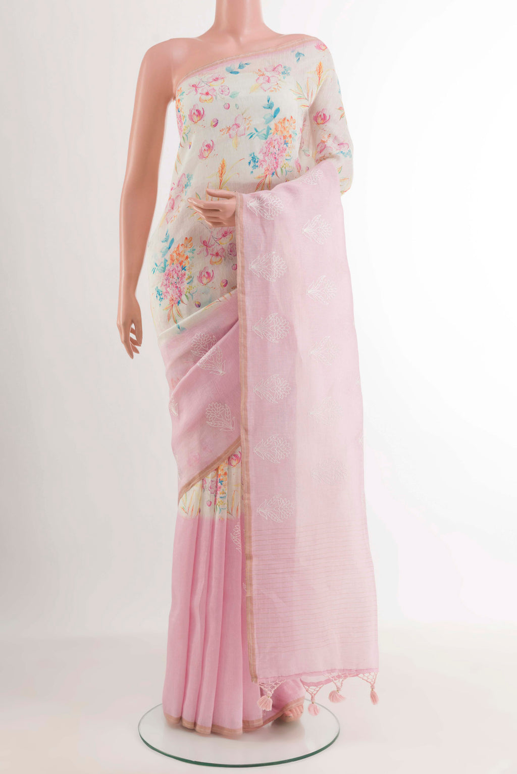 White Linen Saree with Printed design on the body and Zari Border.  displayed on a mannequin