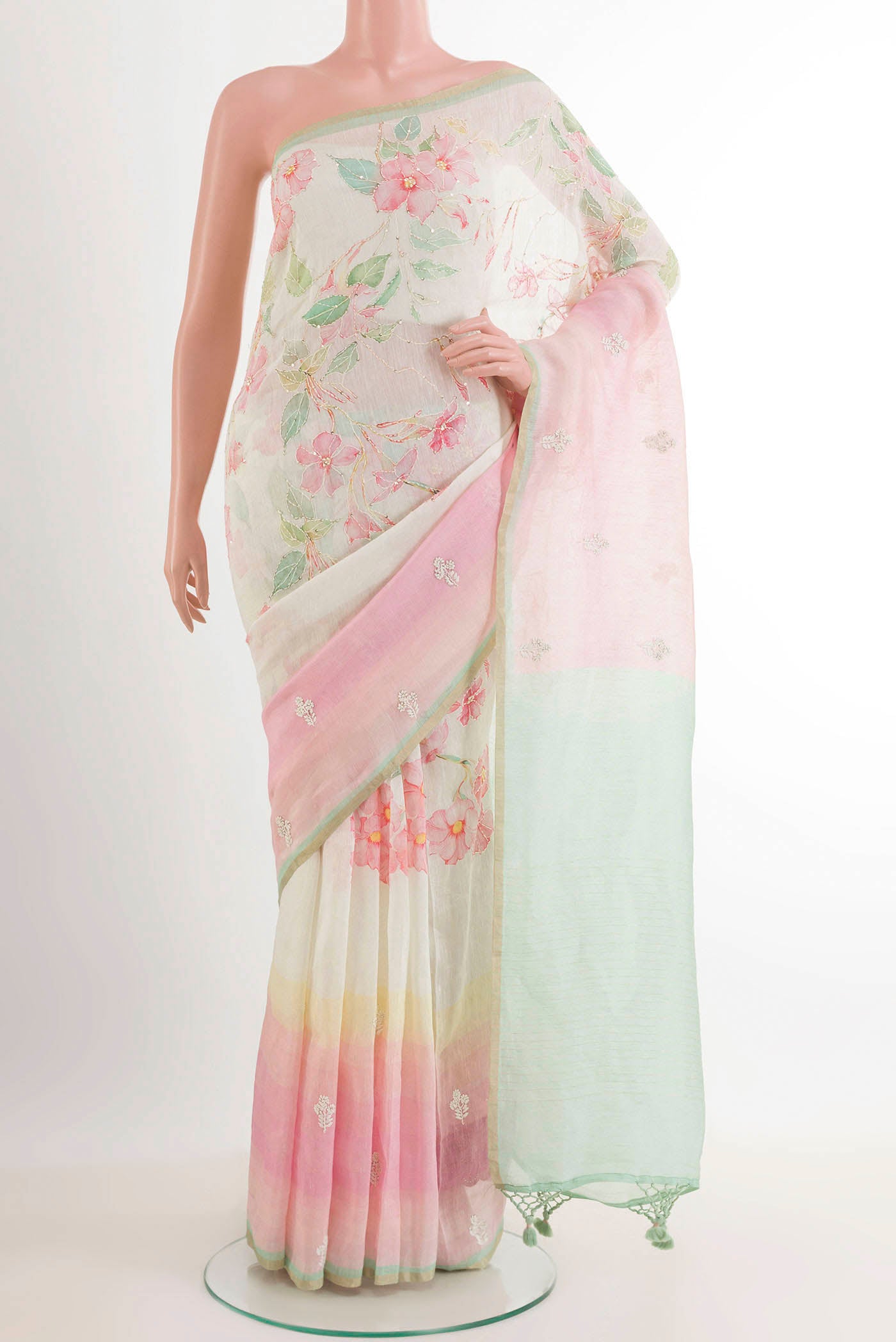 Off White Linen Saree with Printed design on the body and Zari Border.  displayed on a mannequin