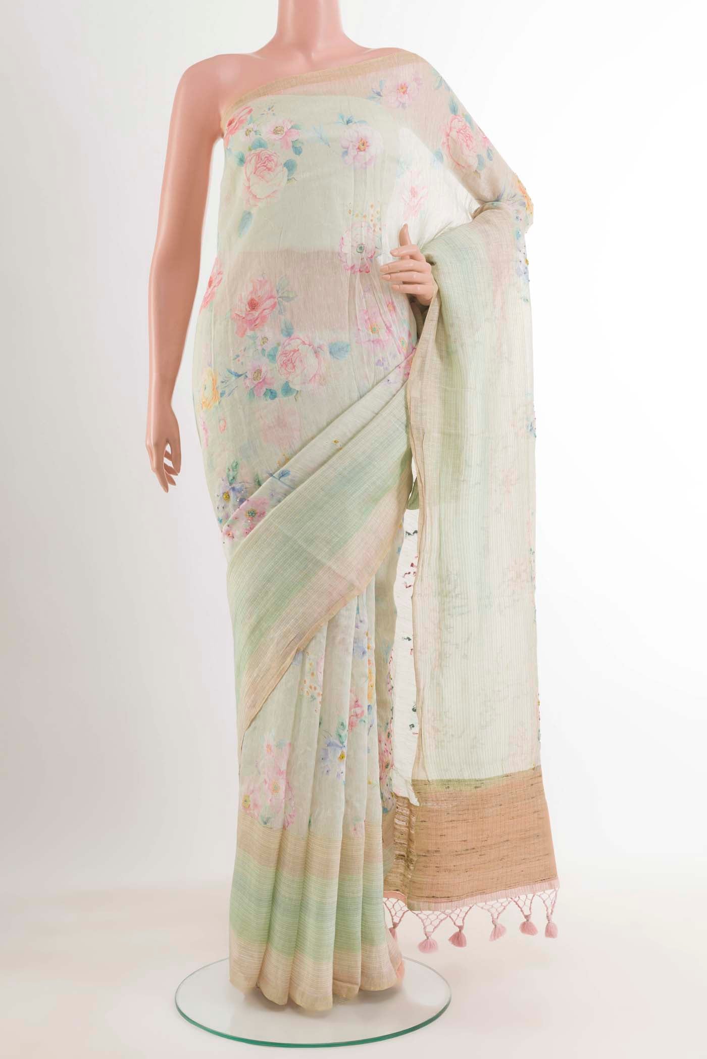 Blue Linen Saree with Printed design on the body and Zari Border.  displayed on a mannequin