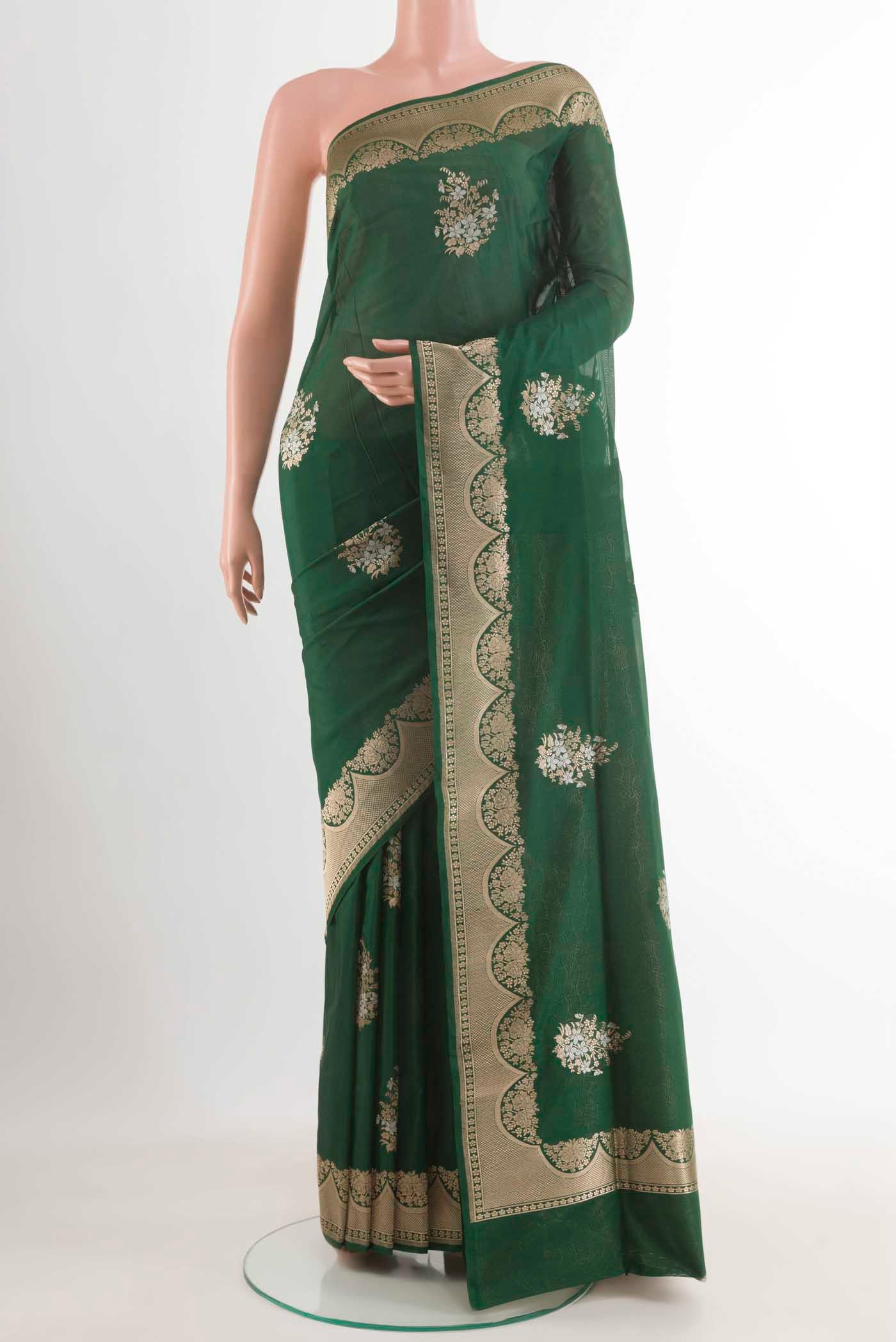 Green Banarasi Silk Saree with Zari Butta on the body and Zari Border.  displayed on a mannequin