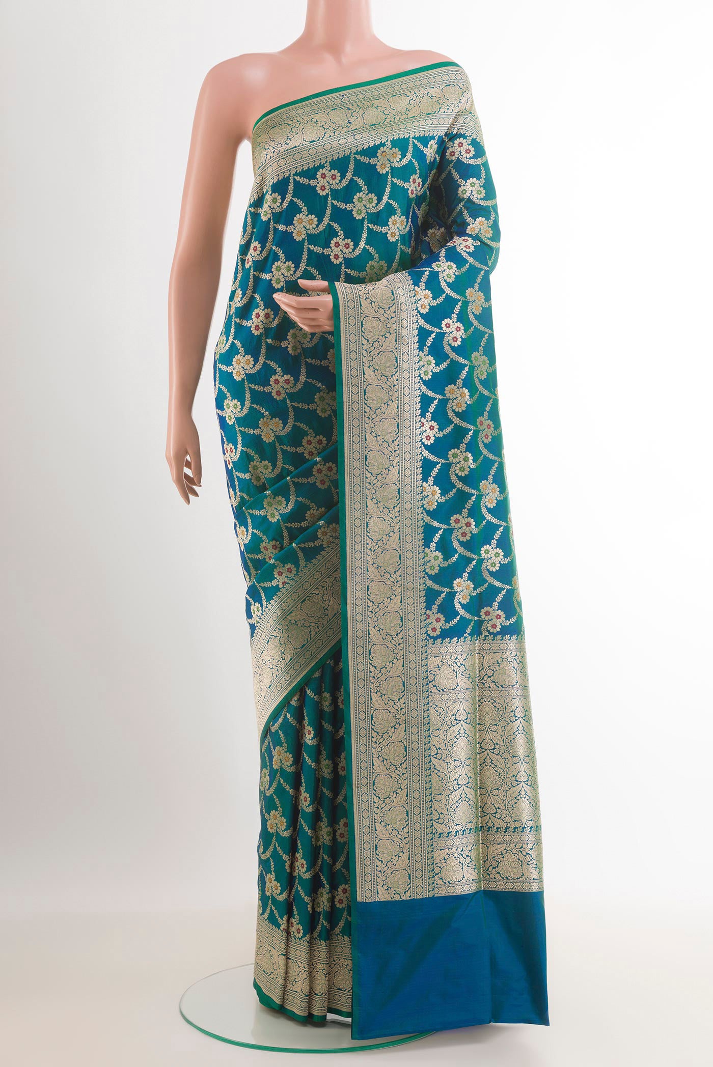 Peacock Blue Banarasi Silk Saree with Zari Butta on the body and Zari Border.  displayed on a mannequin