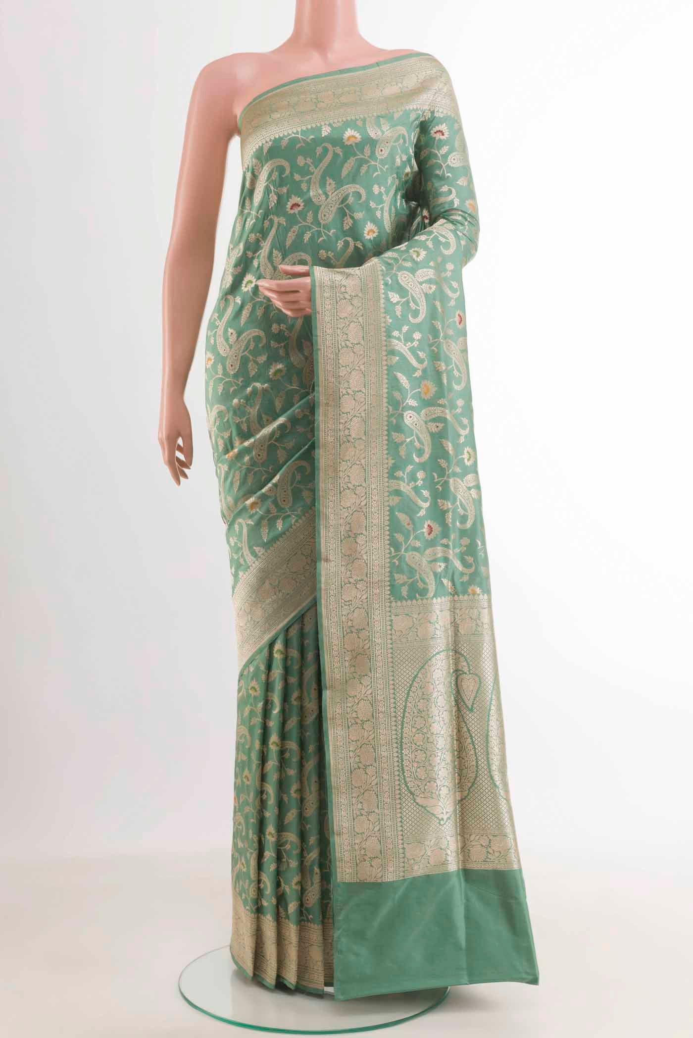 Sage Green Banarasi Silk Saree with Zari Brocade on the body and Zari Border.  displayed on a mannequin