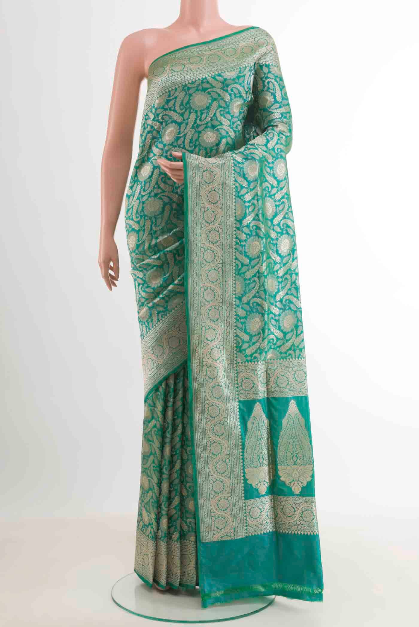 Sea Green Banarasi Silk Saree with Zari Brocade on the body and Zari Border.  displayed on a mannequin