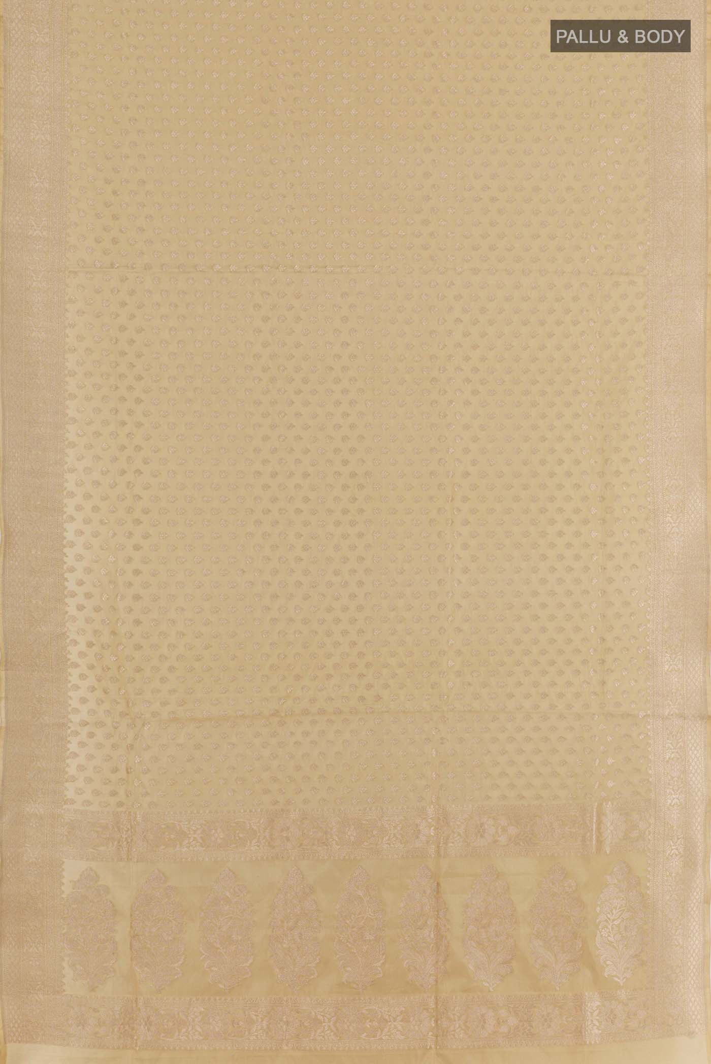 Flat view of Beige Banarasi Silk Saree with Zari Butta on the body and Zari Border. 